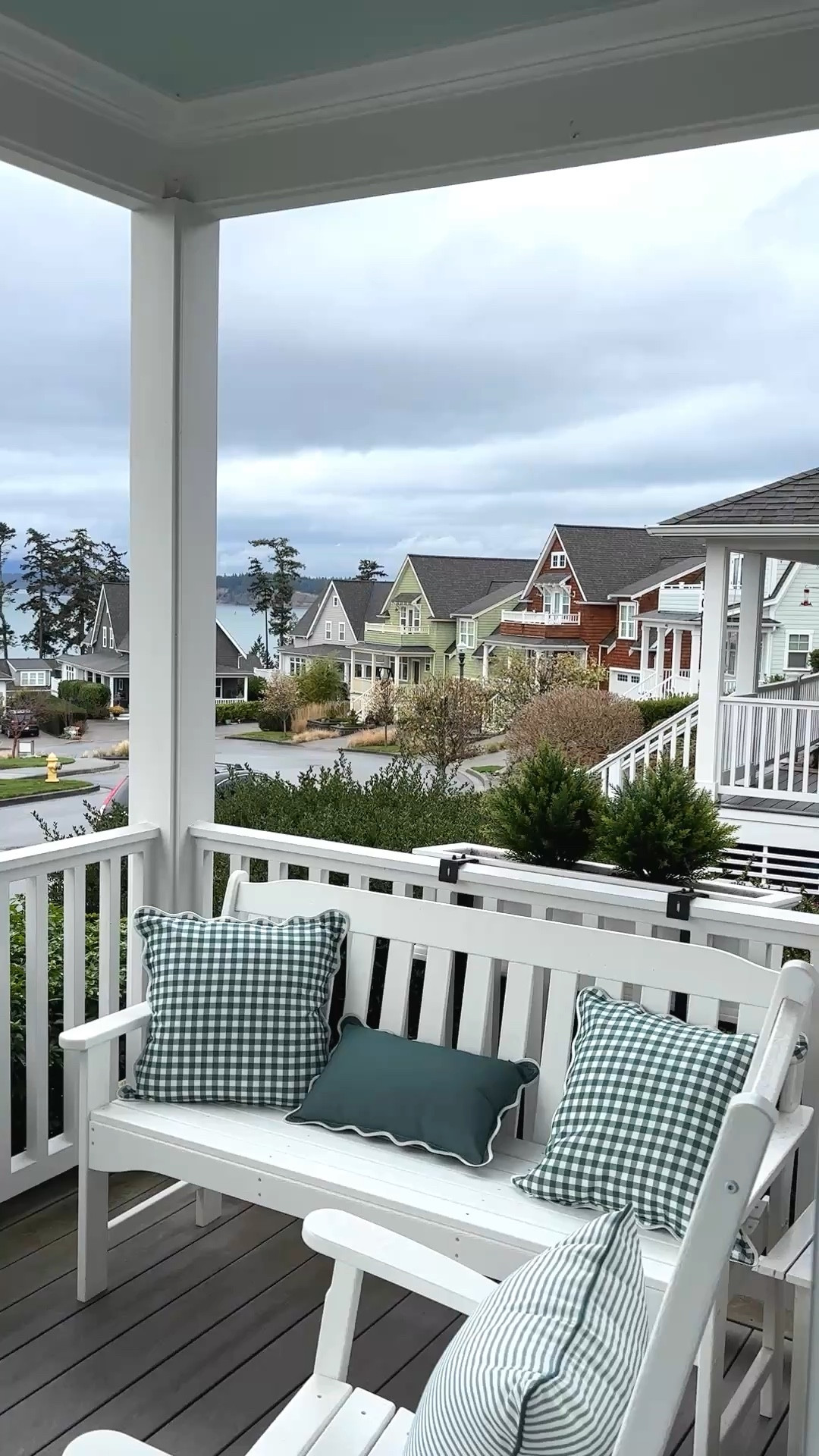 A cloudy day here at our cottage by the sea ☁️  porch sources + similar linked - railing flower boxes with faux cedar plants, gingham pillows, bench and rocking chair, rug

#LTKdayinmylife #LTKHome #LTKSaleAlert