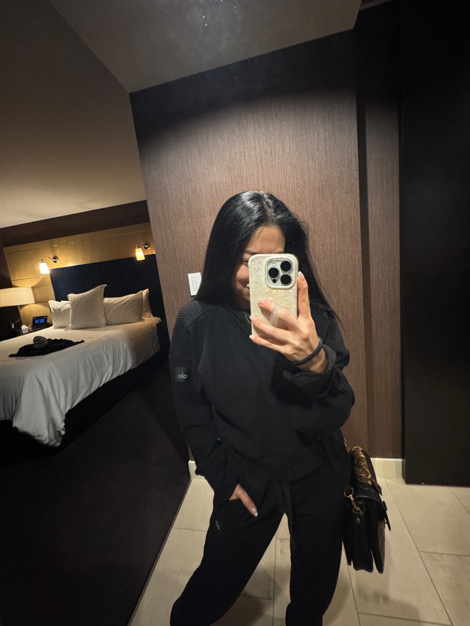 TRAVEL OUTFIT. 
AIRPORT OUTFIT. 
I wires this on my flight to Las Vegas. 
I also linked my exact carryon bag - calpak Luka duffle  
 Alo Muse hoodie and joggers. 
Color: black (I also have in gray and navy). ￼
I wear this set at least once a week  
Hoodie — size small (TTS)
Joggers - size XS (sized down 1). 
Joggers have pockets  
I absolutely love this matching set. The hoodie is slightly cropped but doesn’t show too much. 
Fabric is ribbed and super comfy and flattering. 
Nuuds slinky rib short sleeve shirt - size small (TTS). 
Dr scholls platform sneakers - perfect white sneakers that I often travel with. Super comfortable & TTS. 

#LTKPetite #LTKmomlife #LTKTravel