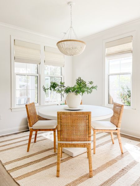 Our Florida coastal cottage dining room with white concrete dining table, rattan dining chairs, bead chandelier, striped jute rug, and our favorite faux greenery!
.
#ltkhome #ltksalealert #ltkunder100 #ltkstyletip #ltkseasonal

#LTKhome #LTKunder100 #LTKsalealert