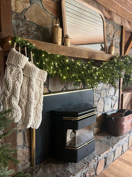 My Christmas decor holiday mantel! I love this Norfolk garland layered! I added fairy lights and it’s so cozy! Christmas stockings, Christmas decor ideas #mantel #Christmas 

#LTKstyletip #LTKhome #LTKHoliday