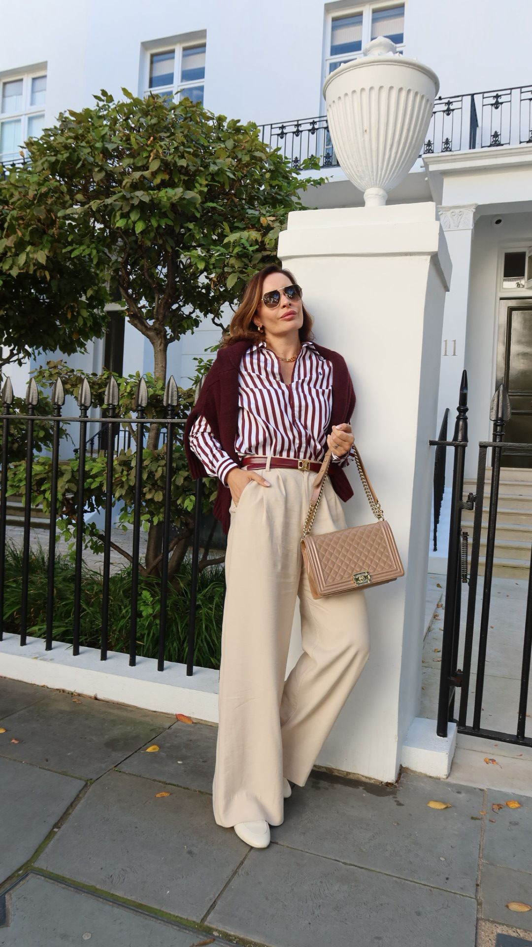 🍂 Fall color staples I can’t get enough of - deep wine red paired with cream. These Nonchalant trousers are the perfect base, styled with a bold striped shirt, a draped cardigan in matching tones, and cinched with a Celine belt. I finished with my Chanel Boy Bag, Gucci Princetown slippers, and gold Missoma jewelry for that polished fall touch. 

 #LTKSeasonal #LTKOver40 #LTKStyleTip