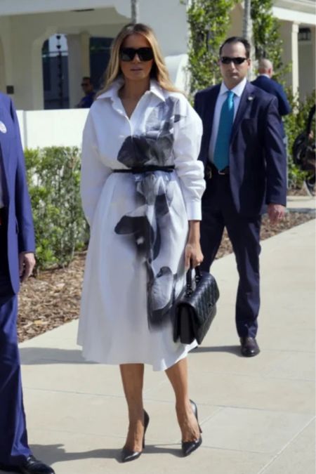 Shop Melania Trump's Poplin orchid Mitty shirt dress and black-and-white Kelly bag and black caviar quilt platform patent pumps #MelaniaTrump #CelebrityStyle

#LTKstyletip
