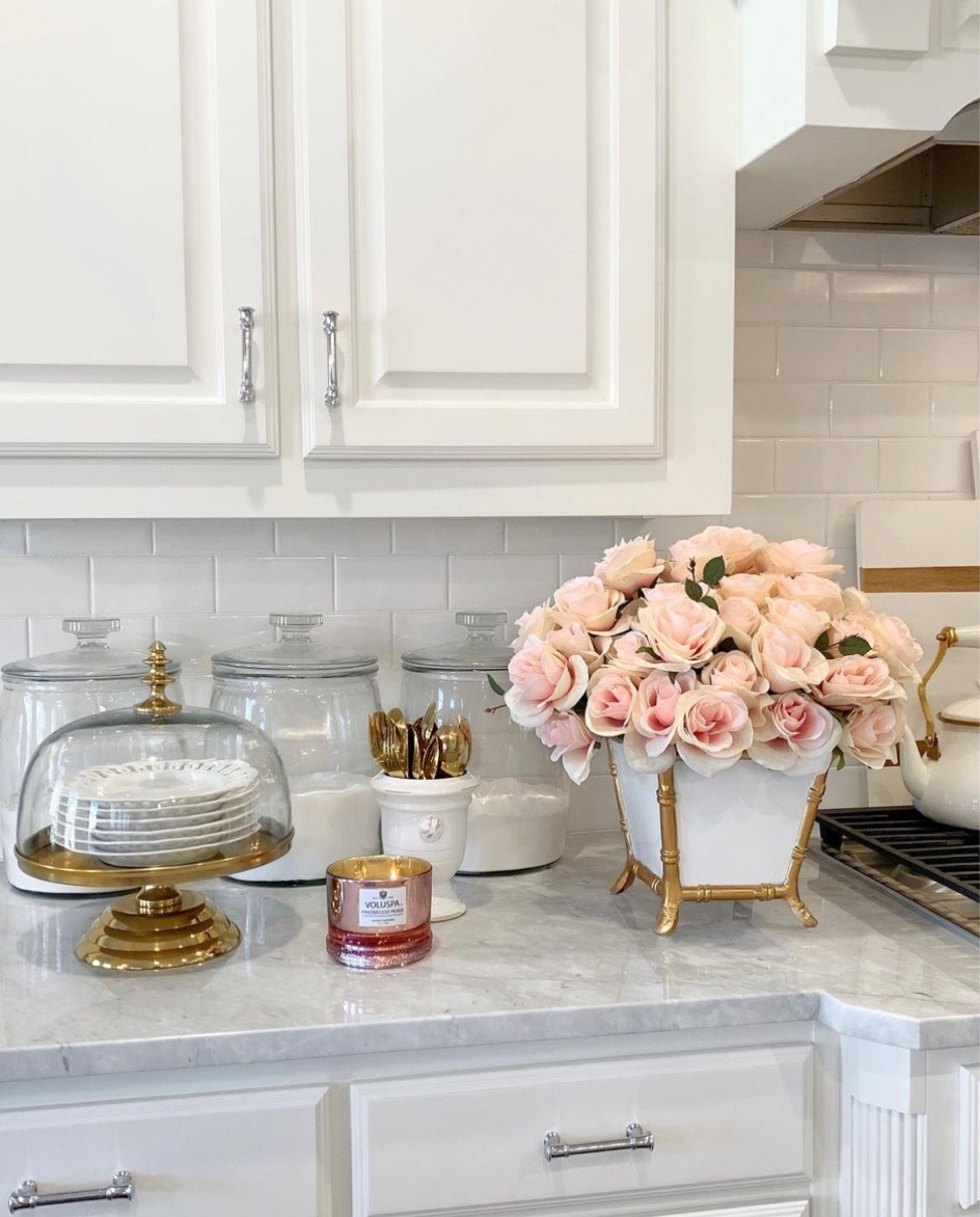 Rose scented candle, Valentine’s Day decor, faux roses, gold cake stand with clocks white kitchen white and gold decor 

#LTKsalealert #LTKhome #LTKFind