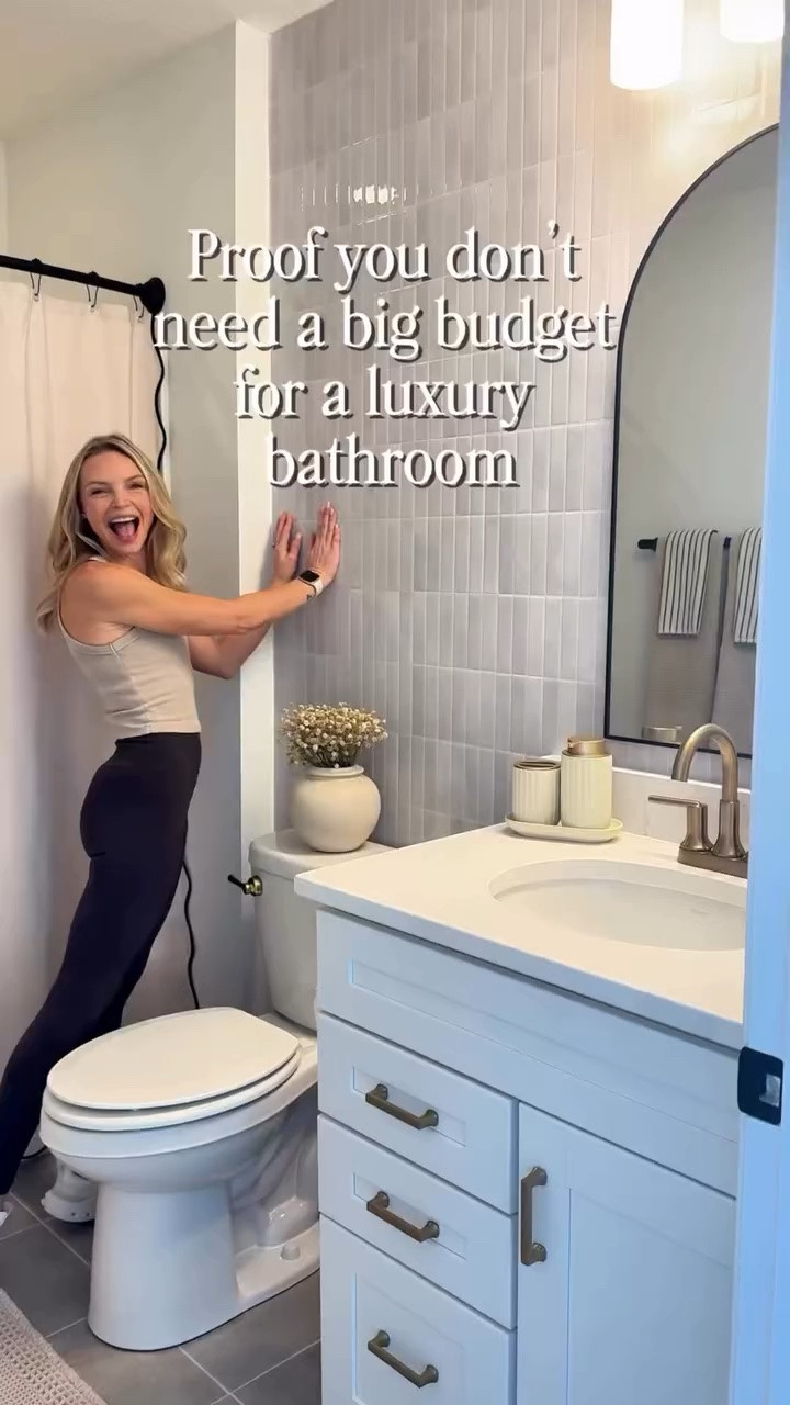 Luxury bathroom look on a budget 🤍

Starting with one of my favorite budget-friendly upgrades: peel & stick tile. Then I layered in a scalloped shower curtain, striped hand towels, and texture through the rug + accents to make the whole space feel more elevated without a full renovation.

Proof that a few small swaps can completely change the look of a bathroom✨

#LTKHome #LTKSaleAlert