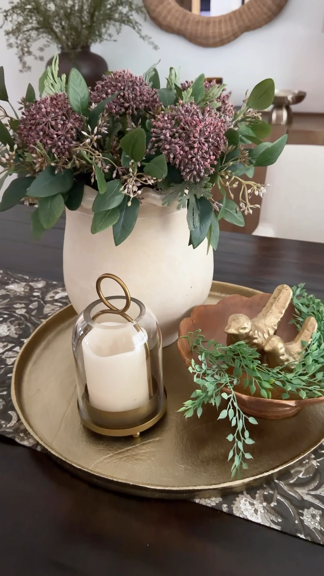 I love this new greenery and sedum stems I just got in, and they just worked perfectly together. I set everything on a gold tray, added a wood pedestal, gold birds and a pretty hurricane lamp. I clipped a little greenery to tuck around the birds. Nothing complicated, just layering as I went. I placed a lantern beside it and called it done.

It’s one of those looks that comes together without overthinking. 
