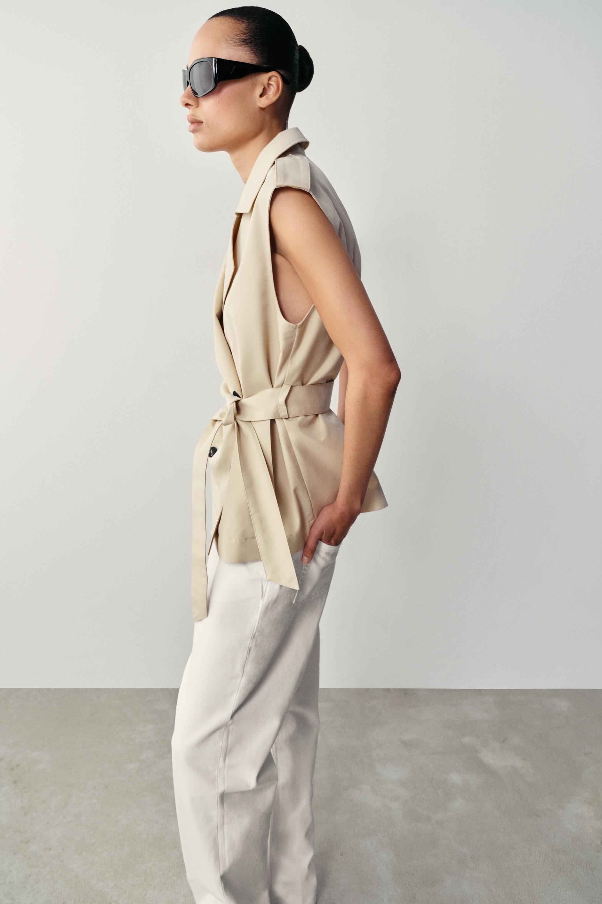 Sleeveless collared vest featuring shoulder tabs. Back darts. Front pockets. Double-breasted butt... | Zara US