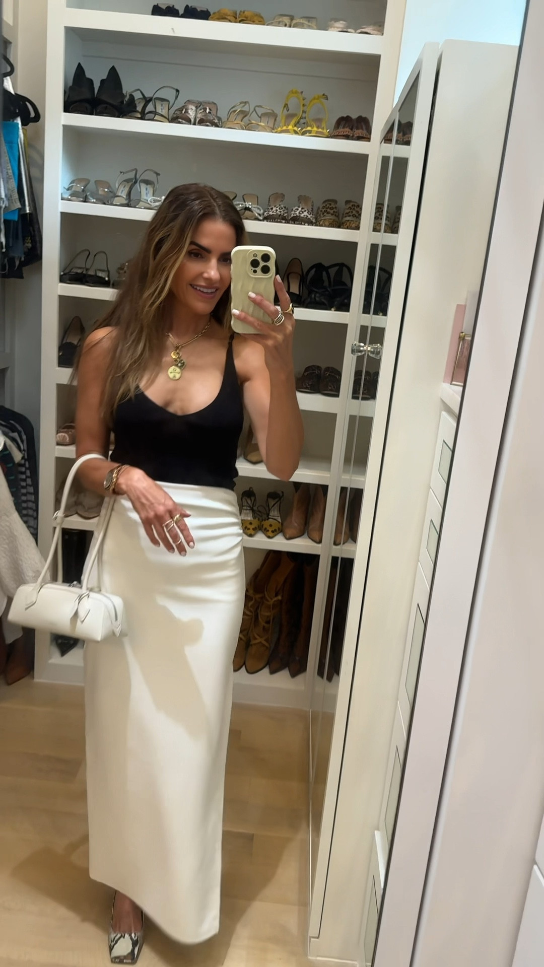 friday look of the night wearing one of my fav color combos blk & wht⚫️⚪️

this tank i love it’s a beautiful knit & i own few colors + this chic half slit maxi skirt that is so super soft & comfy! 

my bag of the summer & gorg snakeskin heels too! 

#LTKStyleTip #LTKFindsUnder100 #LTKWorkwear