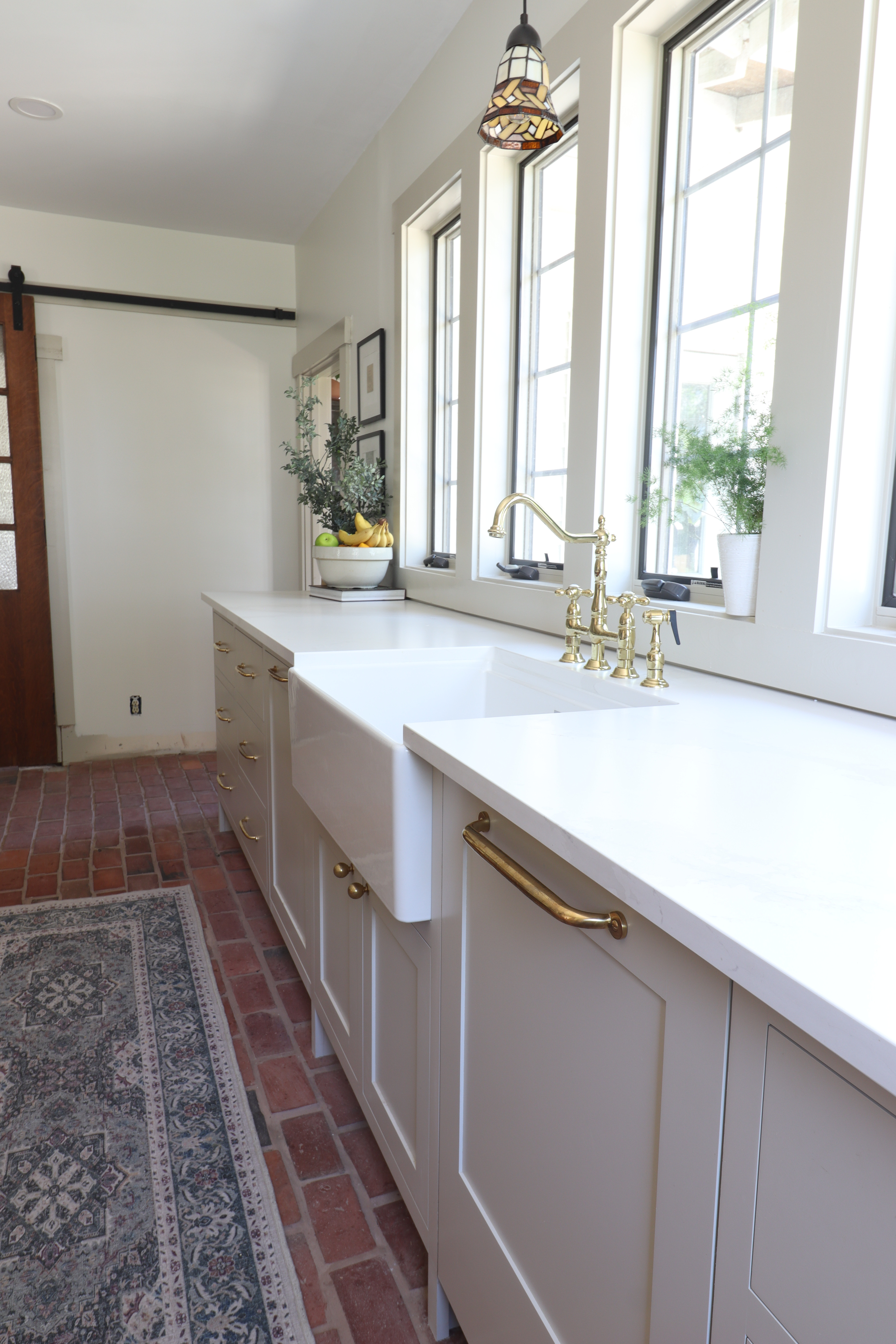 Our brick-floor kitchen is still my favorite view in the whole house. Warm wood tones, creamy cabinets, oversized pendants, and that classic brick… it just hits different. 

 #LTKHome