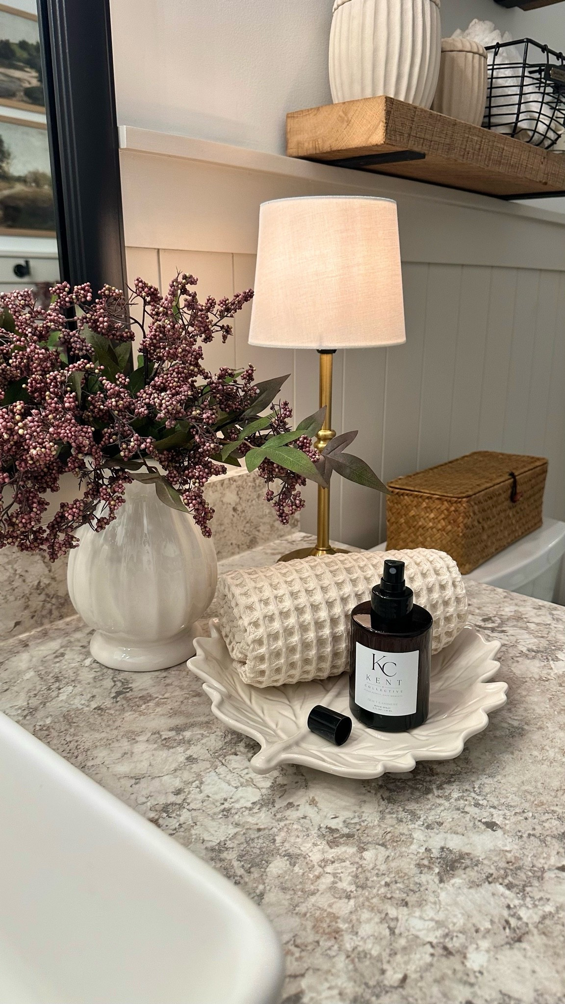 Cozy Bathroom Vignette 🤎

I created this cozy little vignette here in my bathroom space, and I love how it all came together! A warm little lamp, beautiful berry stems, a textured towel, and the prettiest leaf tray add those soft, cozy touches that make the space feel extra inviting.

I also added the Kent Collective Room Spray, and I’m so impressed! It smells SO good, and I especially love that it’s made with clean, nontoxic ingredients. It’s thoughtfully crafted with premium plant-based ingredients, a 100% biodegradable, water-based formula, and leaves behind no heavy residue. The bottle is such a generous size too! Just a few sprays leave the room smelling fresh, clean, and cozy. 🤍#LTKFinds #BathroomDecor #BathroomInspo #CozyHome #FallHome #FallDecor #HomeDecor #HomeInspo #KentCollective #RoomSpray #CleanIngredients #NonToxicHome #PlantBased #CleanHome #HomeFragrance #CozyDecor #SeasonalDecor #HomeStyling

#LTKHome #LTKHome #LTKSaleAlert #LTKSeasonal