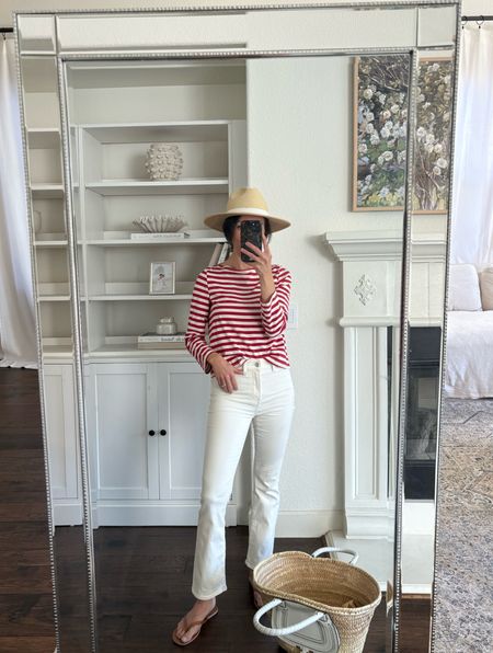 Red striped cotton tee and my favorite off-white jeans. 
Jeans are a color called “vintage canvas”. I went down  size for a more fitted look and feel. I’m wearing the regular length in a 24 waist. 
Tee is Amour Vert. Linking some similar styles. 
Hat is old Target. Linking a similar one. 
Leather flip flops are J.Crew Factory. 
Bag is Chloe.

Madewell jeans
Kick out crop jeans 
Red striped t-shirt 

#LTKSaleAlert #LTKOver40 #LTKStyleTip