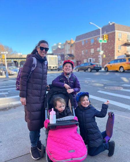 Walking home from school in NYC with backpacks, with a stroller complete with a bunting and hand muffs, and kids on scooters with helmets, and wearing warm coats!

#LTKfamily #LTKkids #LTKstyletip
