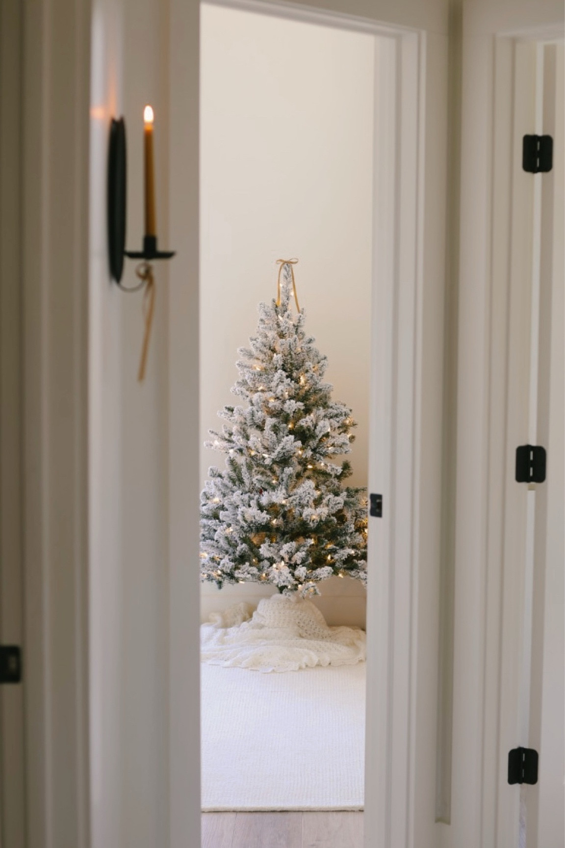 Flocked Christmas tree with lights, neutral wool rug, beeswax taper candle

#LTKSeasonal #LTKHoliday #LTKHome