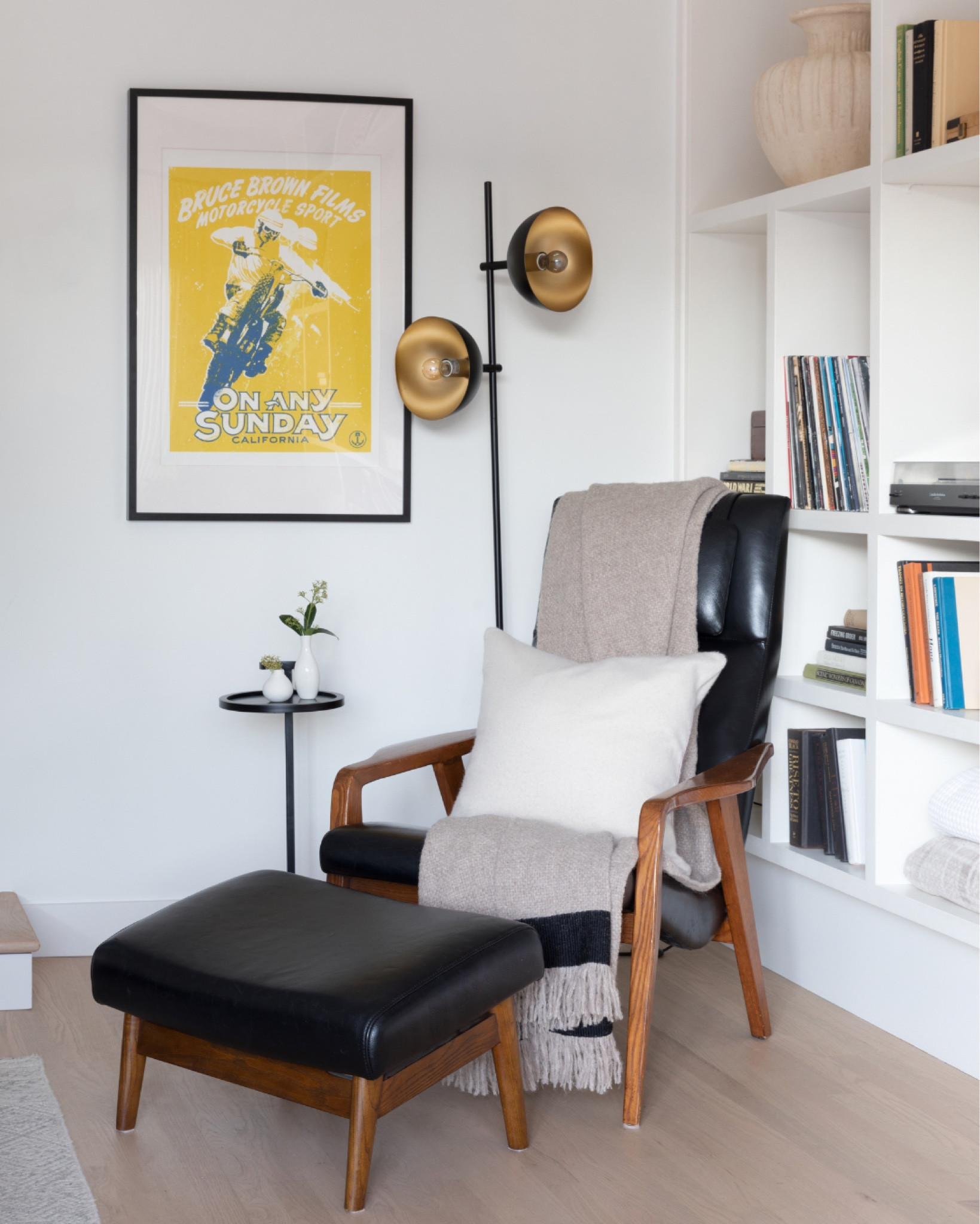 Cozy living room corner. Leather accent chair and ottoman. 

Throw blanket. Wool throw pillow. Statement floor lamp. Black metal side table  

#LTKFind #LTKstyletip #LTKhome