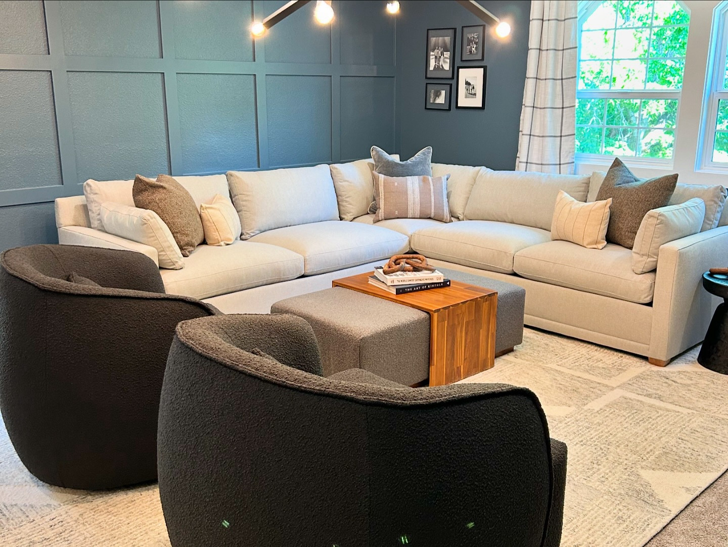 Amber Gamble designed a sophisticated yet family-friendly living room that balances style and functionality. The space features comfortable, durable furniture with plush, stain-resistant fabrics, perfect for busy households with kids. The layout encourages conversation, with seating arranged to foster interaction while leaving room for play.

Amber used warm, neutral tones with a splash of color on the walls and cabinetry. Paneling was added to the back wall to enhance texture and depth. Artwork and family photos provide a personal. The stylish and custom built-in shelving unit offer practical storage, keeping toys and electronics neatly organized and put away.

#livingroominspiration #AmberGambleDesigns #JkEHomeReset #Interiordesign #boisedesigner #idahodesigner #familyroomdesign #familyroominspo #foosball #foosballtable #gameroom