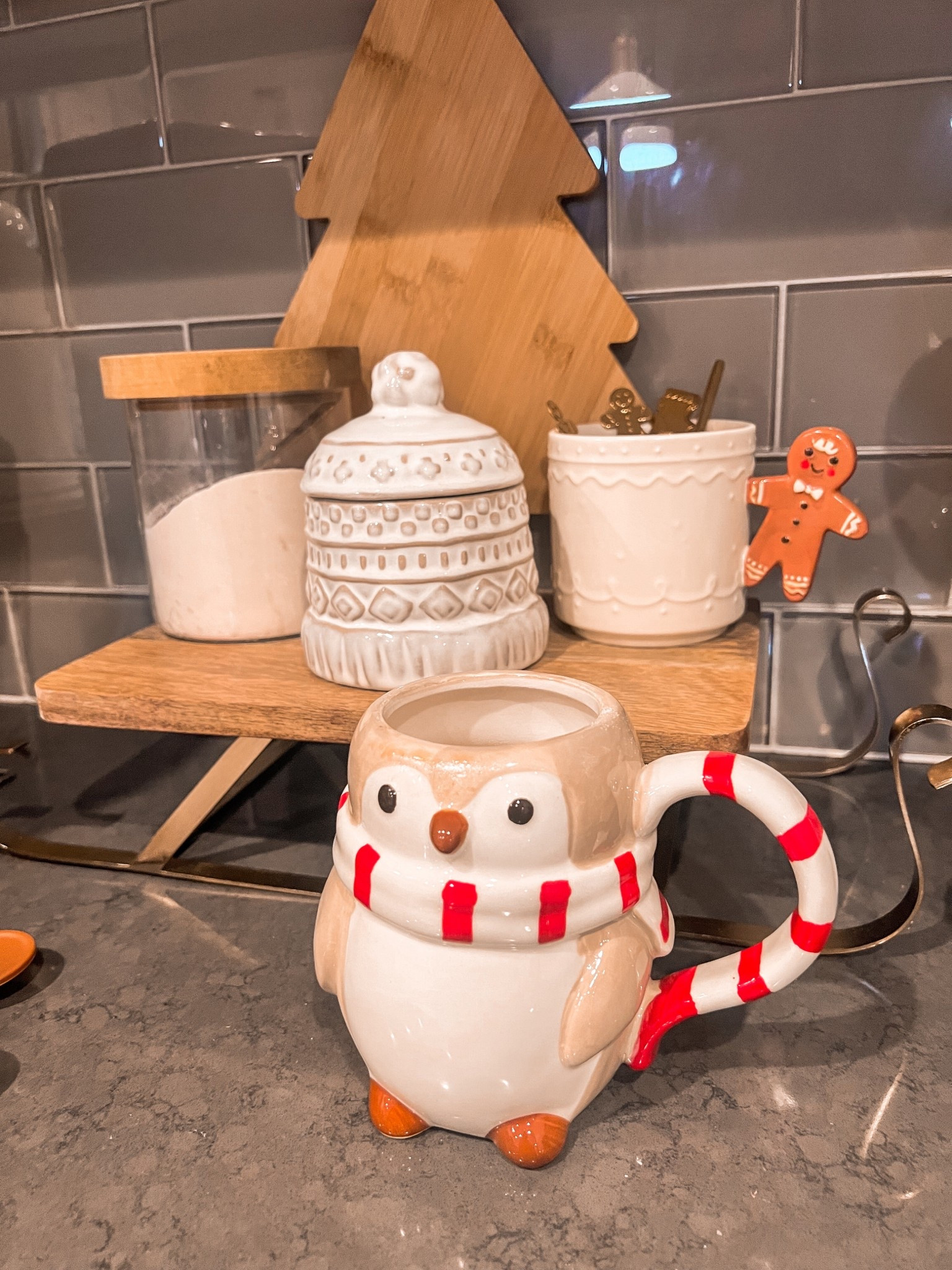 Christmas coffee bar
Wooden and gold sleigh stand
Neutral xmas penguin mug 
Neutral winter hat small jar with lid 
Gingerbread man coffee
Cup 
