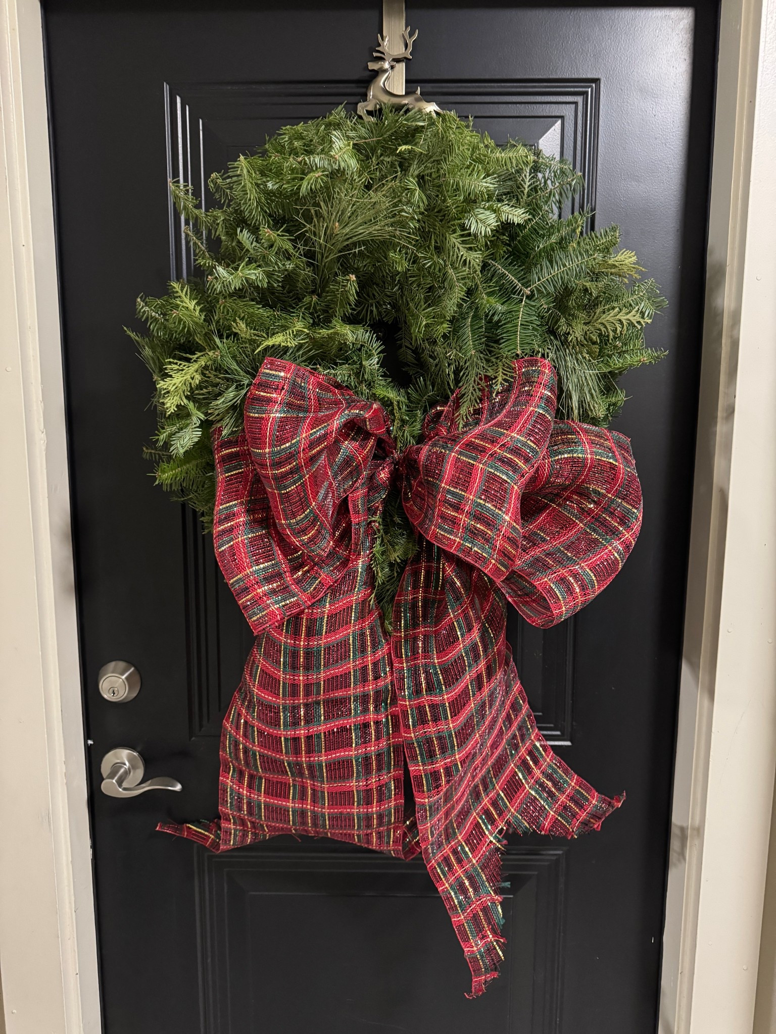 Classic Christmas entry moment 🎄✨
So pleased with how this wreath turned out. The full, fresh greenery paired with the rich plaid bow feels timeless, festive, and welcoming the moment you walk up to the door. It’s one of those pieces that instantly sets the tone for the season without needing anything else.

I love décor that feels traditional but still elevated this wreath does exactly that. Linking similar holiday wreaths and bows for your own front-door moment 🤍✨

I got the wreath with added mixed greens!

#LTKHome #LTKFindsUnder100 #LTKHoliday