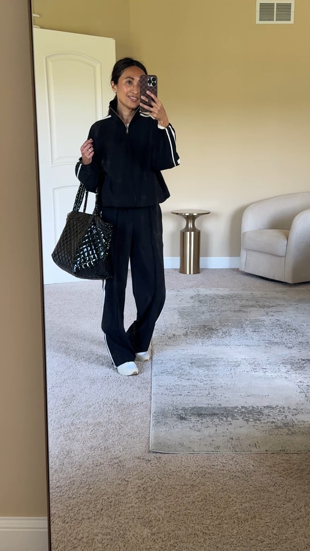 Track pants. Trending style for Fall. Current 30% off  
-This exact pair is a good dress up or dress down option because of the elevated material and drapey fit which feel dressy. Effortless chic vibe. Wear as a travel outfit and wear on your trip to go out to dinner with a dressy top and heels.   I sized down and took the petite length at 5’4 and would still need a chunky sneaker or low heel if I was dressing them up. 
-This coordinating track jacket feels so stylish. Same elevated fabric, with a roomy fit through the body. Cinchable waist to give shape and zip pockets. I love the collar and side stripe detail. True to size for me. I’d wear this jacket with jeans too. 
-Henley top is a good basic athleisure style. Nice ribbed material and detailing. I sized up as it seems to run small through the body. 
-Neutral chunky sneakers that I have had for years. Size up. 
-Travel bag that is also an old favorite in an eye catching black lacquer finish with popular styles that are back in stock. 


#LTKTravel #LTKActive #LTKOver40