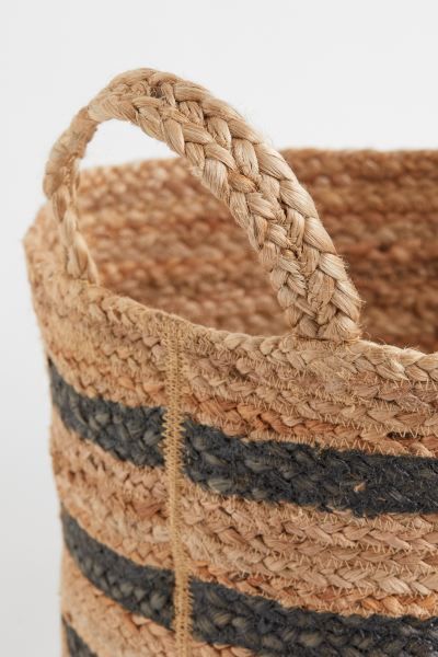 Cylindrical storage basket in jute with a printed pattern. Handles at top. Height 11 in. Diameter... | H&M (US + CA)