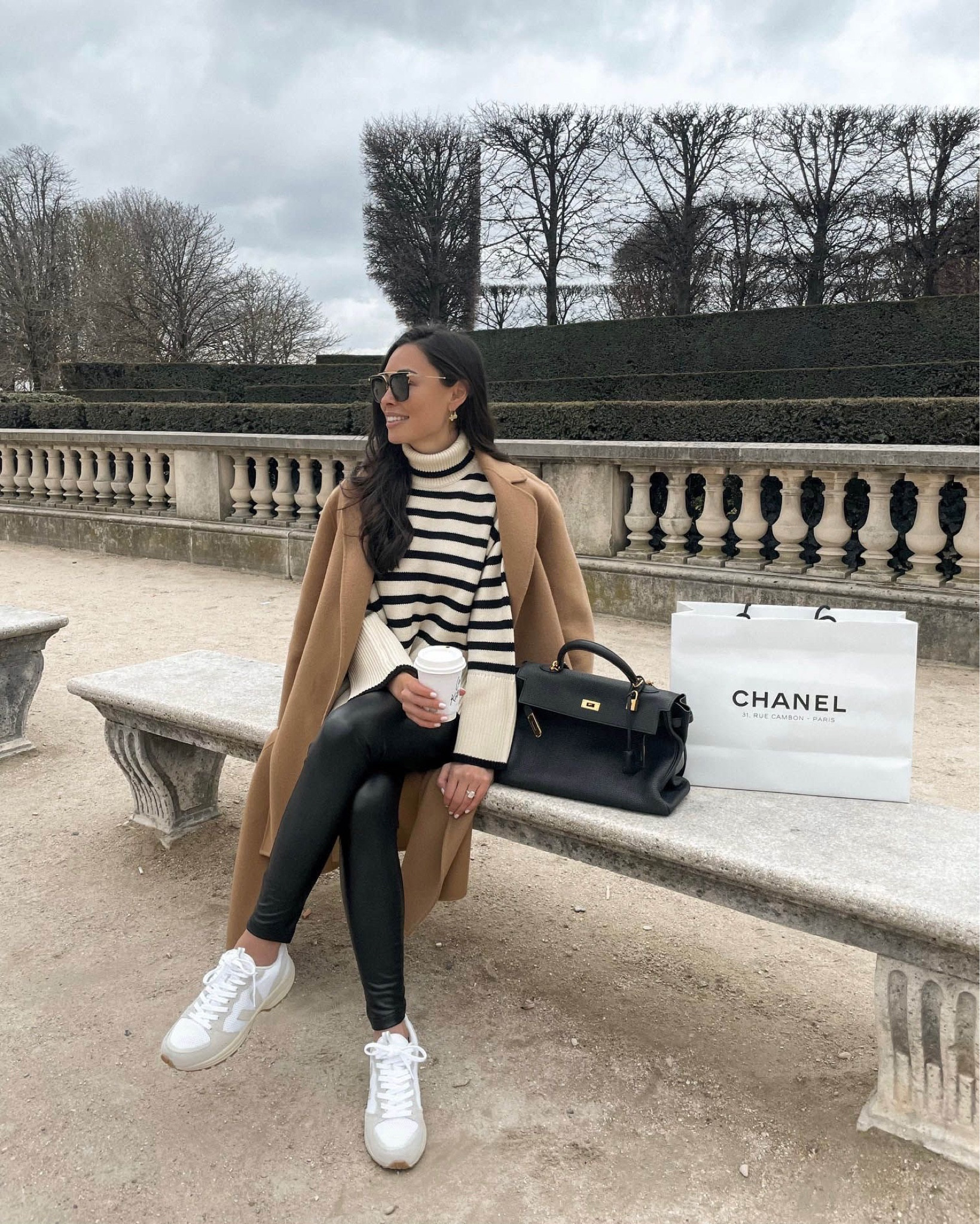 Kat Jamieson of With Love From Kat wears a fall outfit. Striped sweater, camel coat, white sneakers, black leather leggings, sunglasses, fall style. 

#LTKstyletip #LTKSeasonal