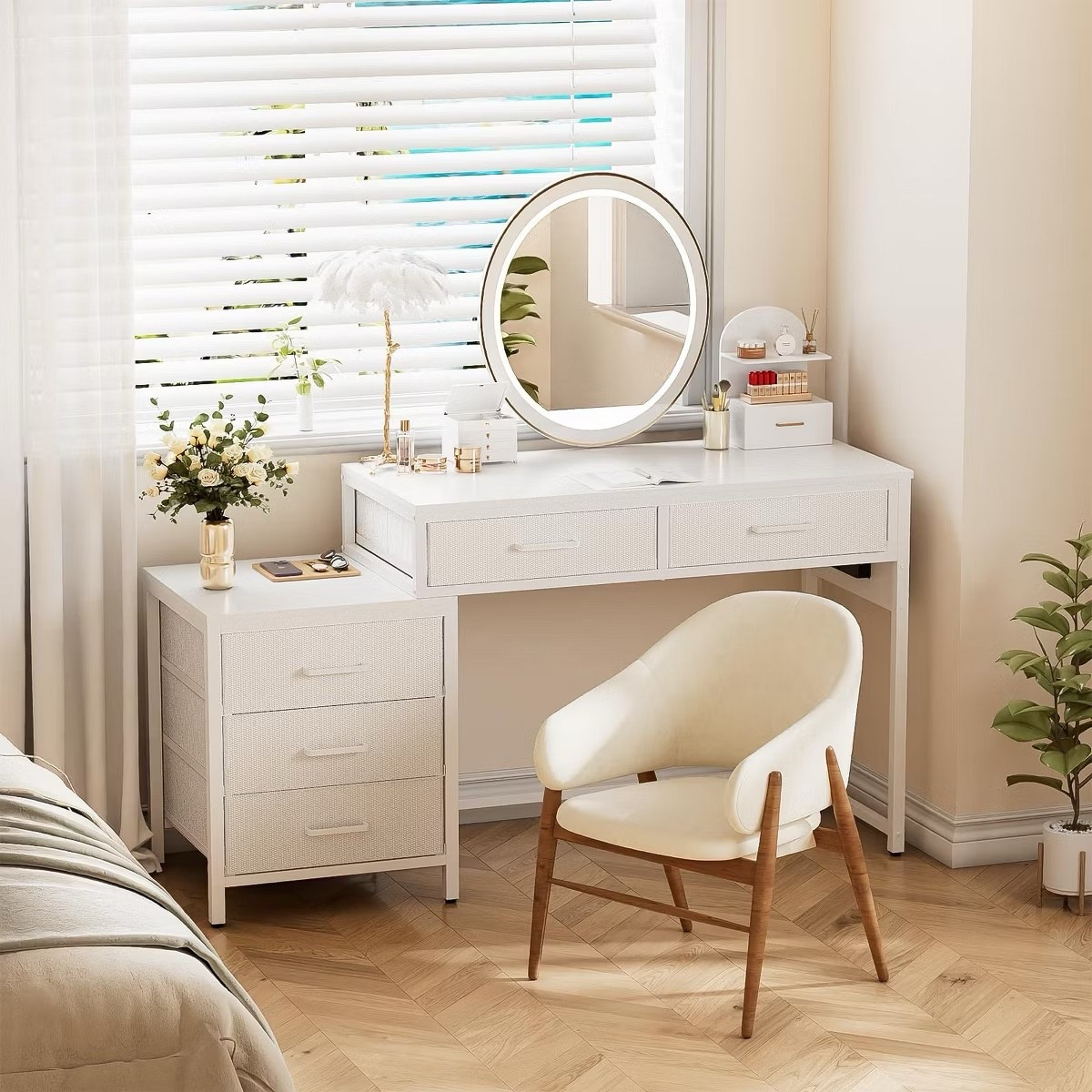 This modern white vanity desk with a lighted round mirror is the ultimate bedroom upgrade. With multiple storage drawers, a chic vanity chair with wooden legs, and elegant decor accents, it’s both functional and stylish. Perfect for makeup, skincare, or getting ready in the morning, this vanity setup creates a calm, organized space that feels luxurious while staying practical.
