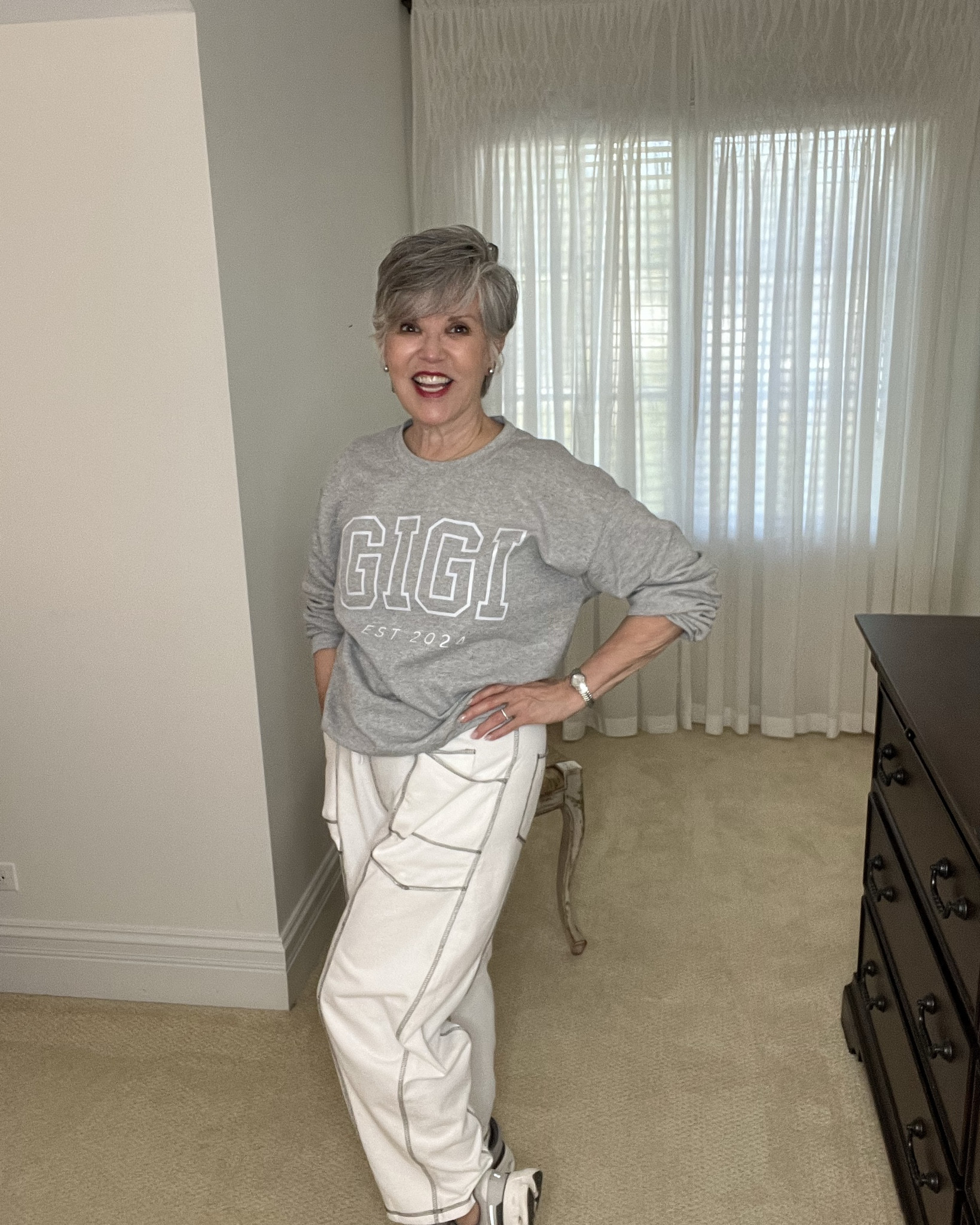 Gigi sweats
"Think sweatpants can't look chic? Think again. Here's how to rock a cozy sweatshirt and barrel sweatpants combo — polished, effortless, and perfect for women redefining style over 50. 👏"
My son and daughter-in-law got me this darling sweatshirt once they had a baby. Now I’m Gigi to them. I paired the sweatshirt with these oh-so-comfy and stylish barrel leg sweat pants. They have grey topstitching and really work with the top and my fun gym shoes. See if you have a grey sweatshirt in your closet (or your hubby’s !) that could work with these fashionable sweatpants! You will love this look. 

#LTKActive #LTKFindsUnder50