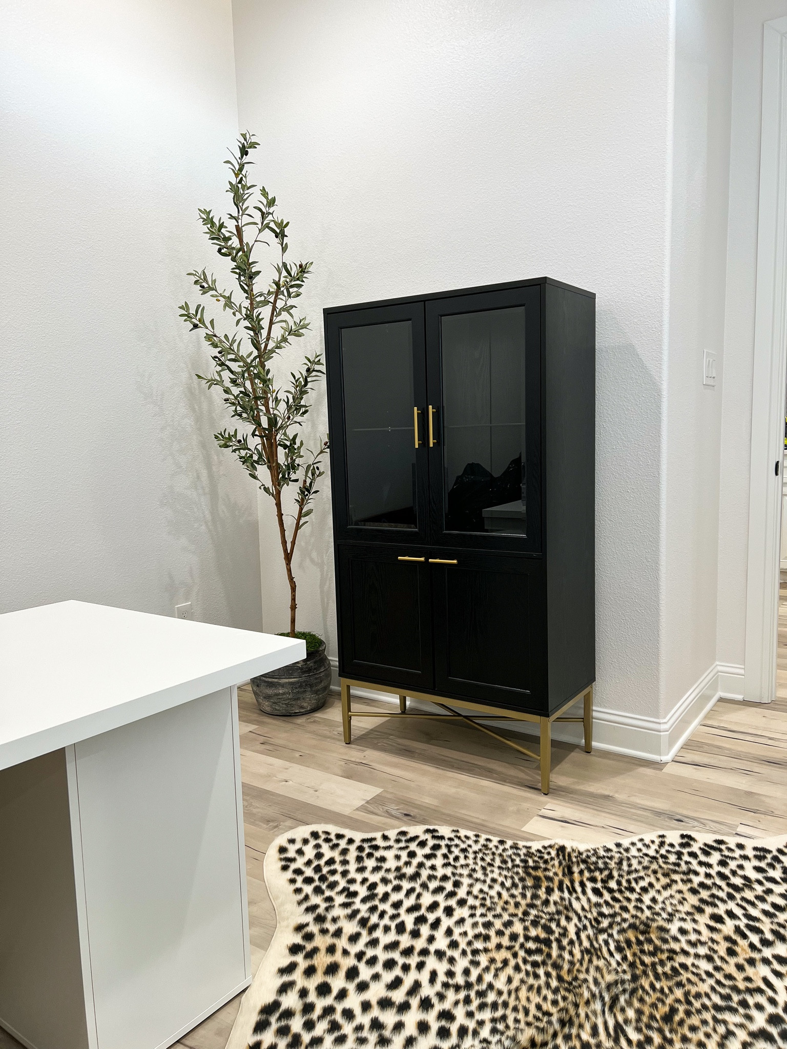 Bar cabinet, storage cabinet, half glass cabinet, black and gold, modern cabinet, glass, olive tree, leopard, faux hide rug, accent rug, office furniture, Wayfair, Amazon.

#LTKsalealert #LTKhome #LTKunder100