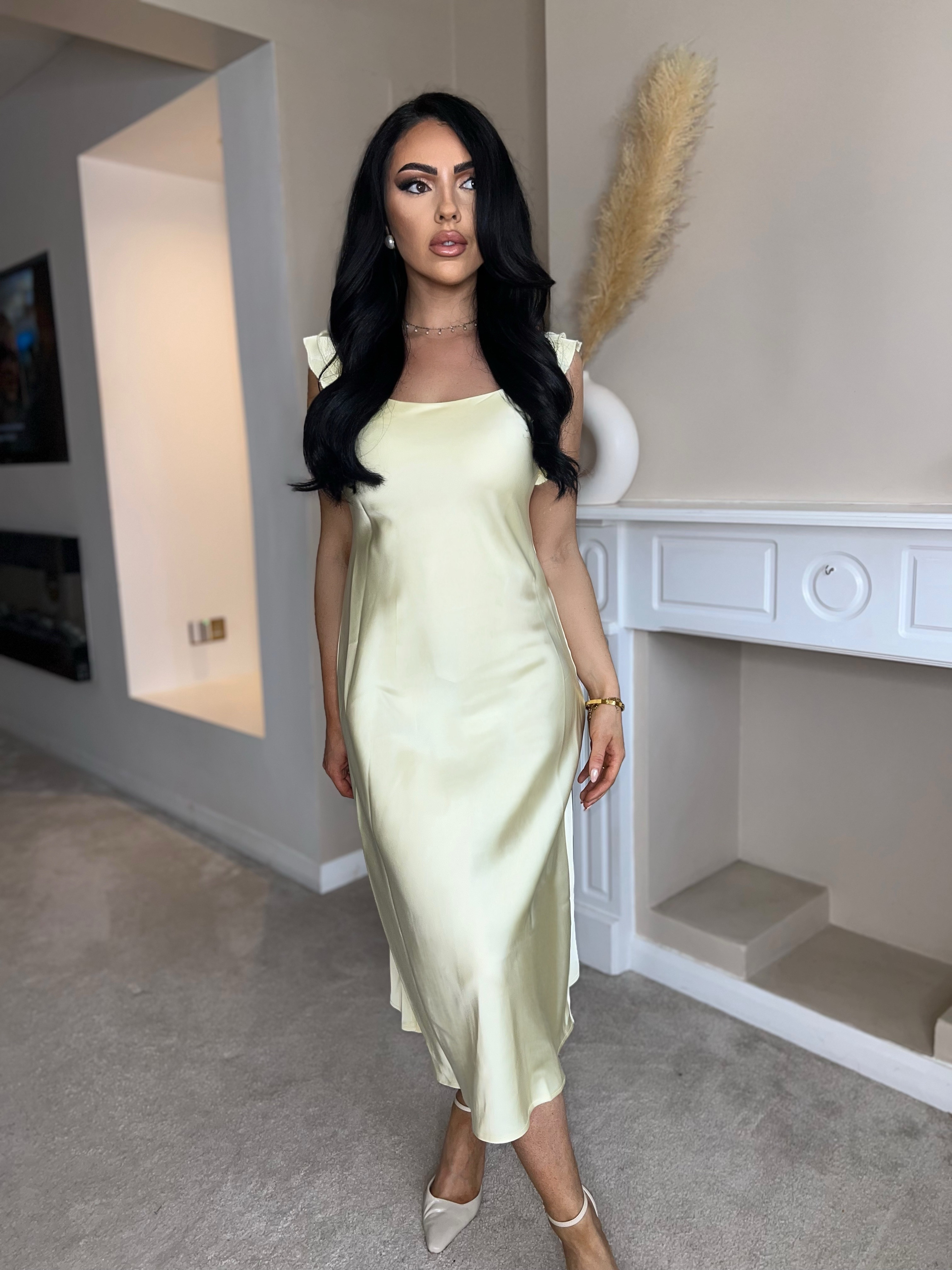 This dress is giving pure sunshine energy ☀️💛
The satin finish, soft ruffle sleeves, and that buttery yellow tone = a total dream. So lightweight and floaty — I can’t think of a prettier look for a summer wedding or even as a bridesmaid dress.

I’m wearing size S and I’m 5'5" — the fit is perfect, super flattering and skims the body without clinging. It feels luxe on the skin and moves beautifully when you walk.

Styled it with some classic pointed heels, a dainty pearl earring, and soft glam makeup — such a timeless, romantic vibe 🕊️

Honestly, this would be gorgeous for weddings, garden parties, or any dressy summer event. 

 #LTKsummer #LTKwedding #LTKluxury