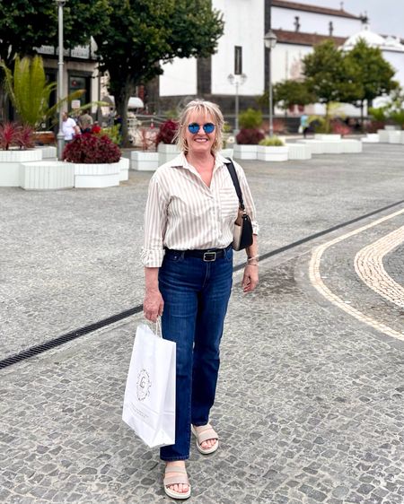Bootcut jeans with striped shirt and super comfy sandals. 
The sandals are incredibly comfy and perfect for long days sightseeing  

#LTKtravel #LTKstyletip #LTKshoecrush