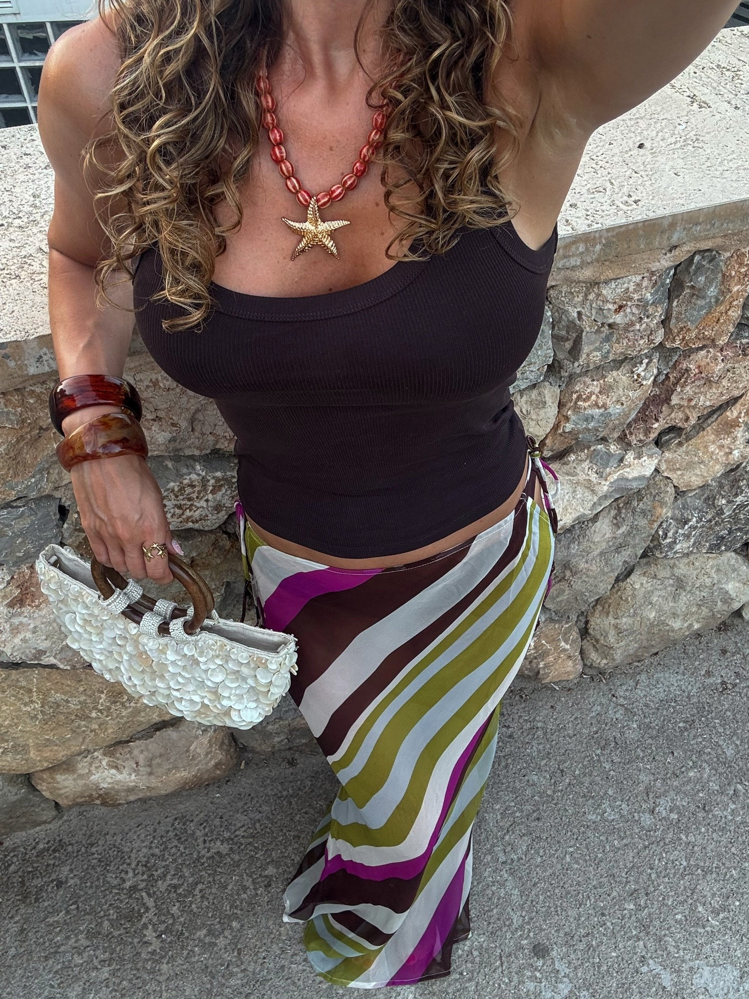 This sheer maxi skirt is perfect for beach to bar and even comes with the matching bikini which I’ve linked below. Styled with a brown tank top, bangles and a starfish beaded necklace for an evening look in Mallorca 🐚✨

#LTKuk #LTKsummer #LTKeurope