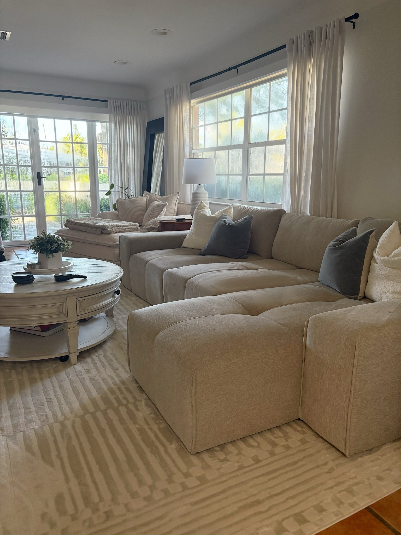 Our living room just got a cozy-chic update! I’m obsessed with this neutral modular sectional—it’s spacious, comfy, and blends perfectly with the soft-toned rug and textured pillows. The natural light from the large windows makes this space feel bright and inviting. I styled it with a round coffee table and neutral accents for a clean, calming vibe.

#LTKHome