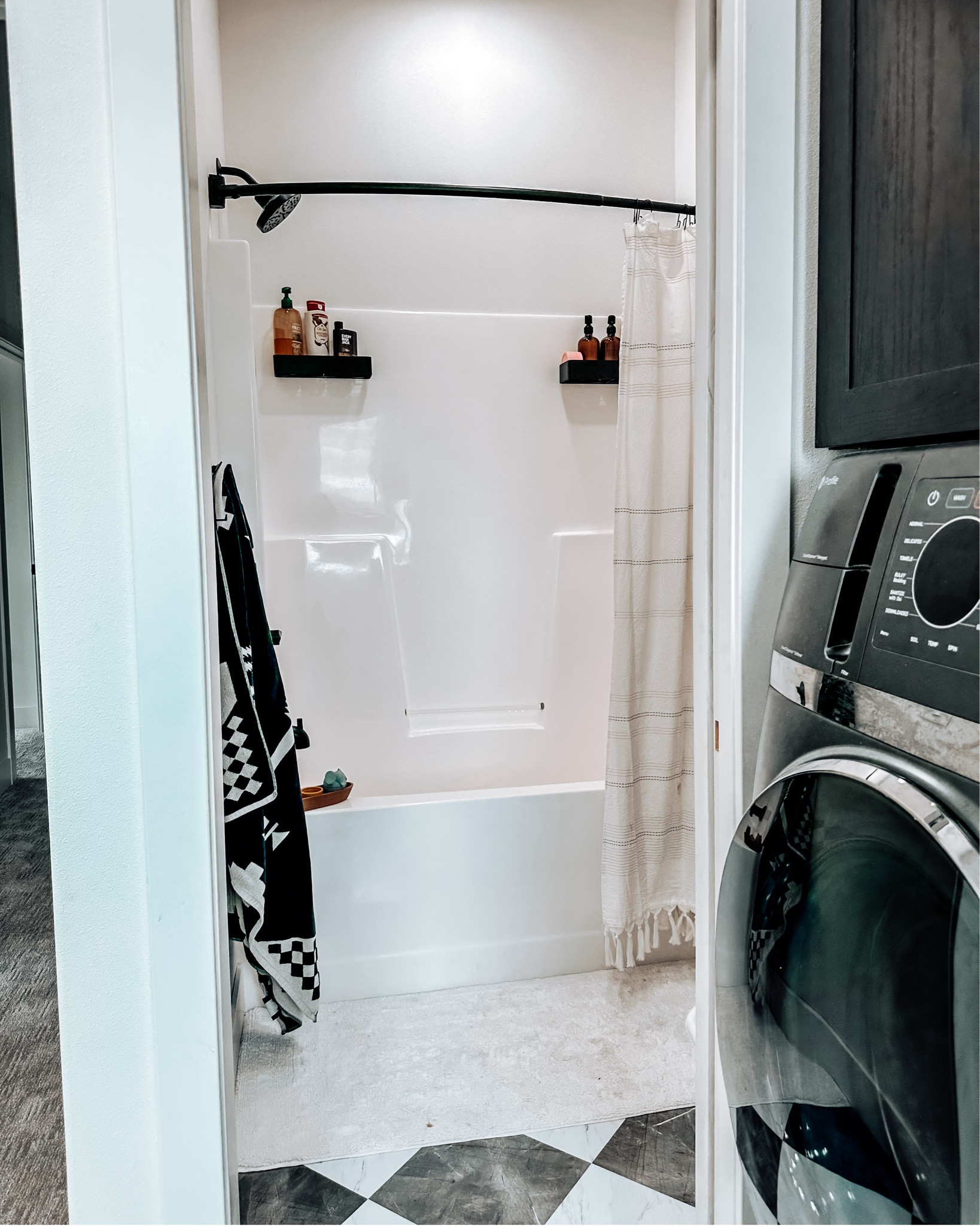 The curved shower curtain rod and the baskets on the shower wall are game changers! Also, love the hooks. So much easier to get 6 towels in here. Having a rug go the full length of the tub has also been super functional for kids and splashes.
We did the floor ourselves — super doable. Paint color is Benjamin Moore White Dove which is much warmer & creamier than the floor but it’s working for now  

#LTKhome