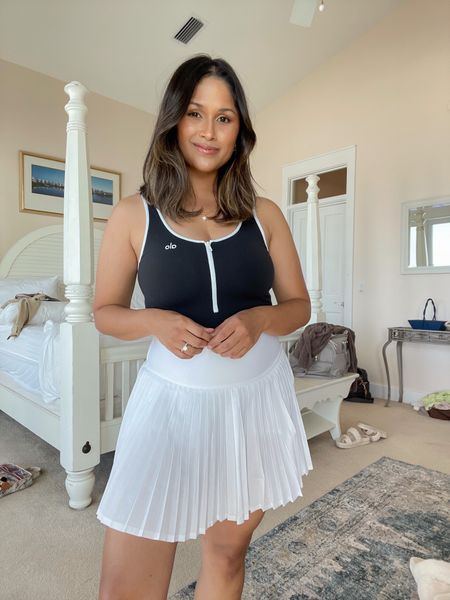 My favorite tennis skirt is on sale at Alo! 30% OFF sitewide including this really cute bodysuit with the zip front detail. No code needed! Wearing size medium in skirt & small in bodysuit. 
…
#aloyoga #activewear #tennisskirt #whiteskirt #tennisoutfit 

#LTKsalealert #LTKunder100 #LTKfit