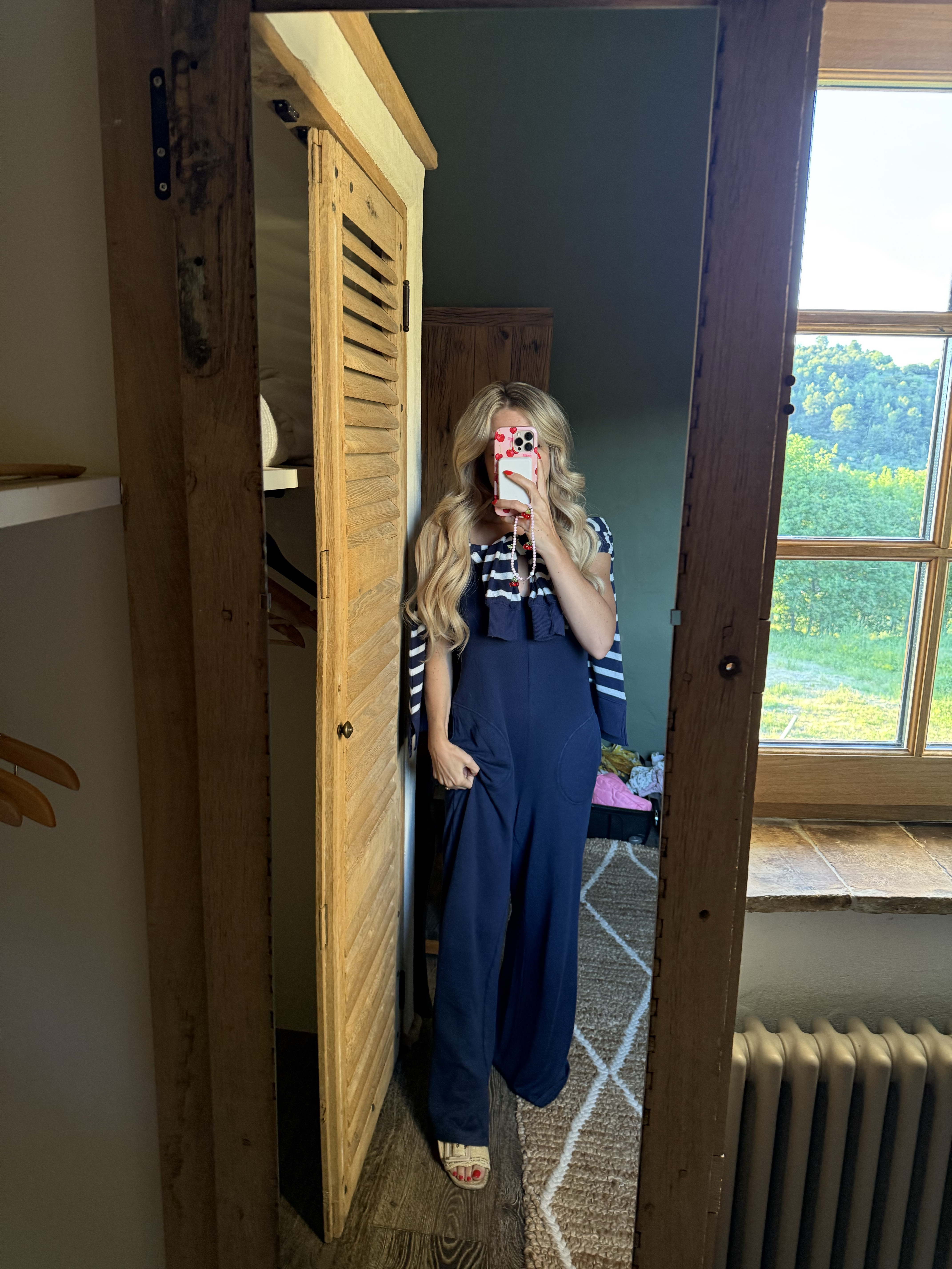 My comfy cozy travel outfit from juvenile to Provence. Oversized jumpsuit and striped sweater perfect for travel 