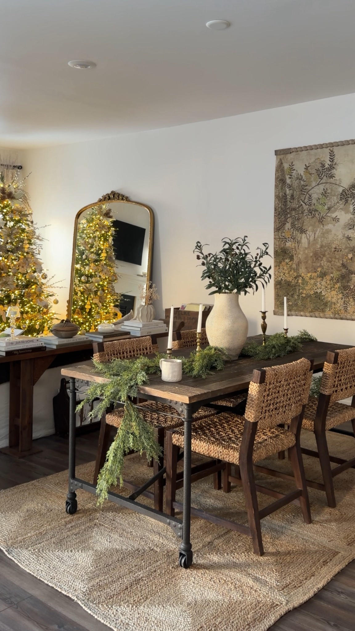 12/16/25 our cozy holiday living room and dining area. I’m linking our Christmas tree, my Anthropologie tapestry that I’ve been getting so many questions about lately, and our large statement mirror from Anthropologie. I’m also linking the natural jute rug from Rugs USA that I just added to the dining room. Most of the other pieces in these spaces are vintage, secondhand, or older finds that I can’t link, but I wanted to share the overall cozy holiday vibe and the pieces I can still source for you.

#LTKHoliday #LTKHome