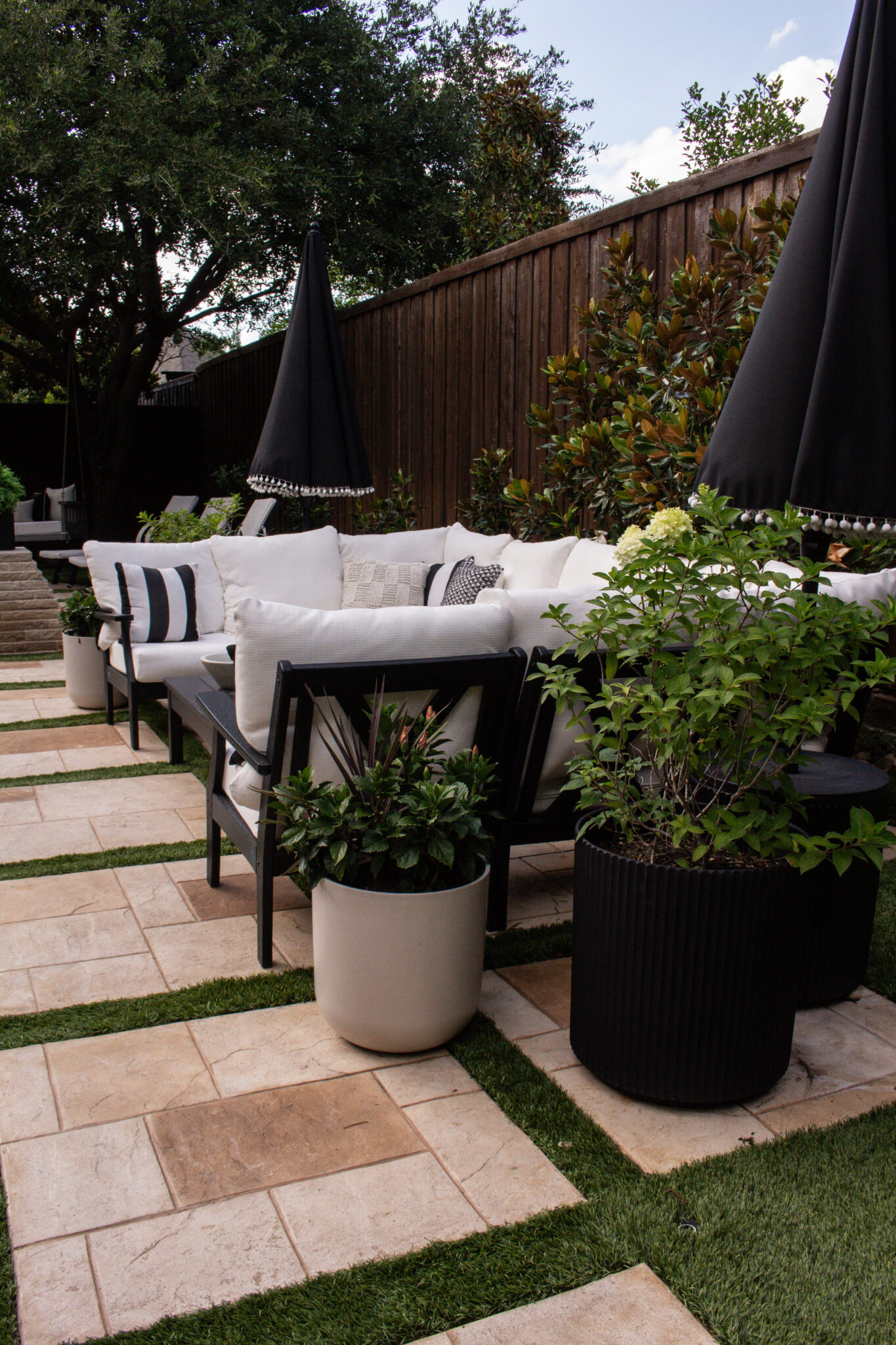 This black and white transitional backyard is full of timeless outdoor inspiration! Think cozy conversation spaces, beautiful dining areas, classic planters, comfortable seating, and elevated decor that's perfect for outdoor entertaining all season long.

#LTKSeasonal #LTKHome