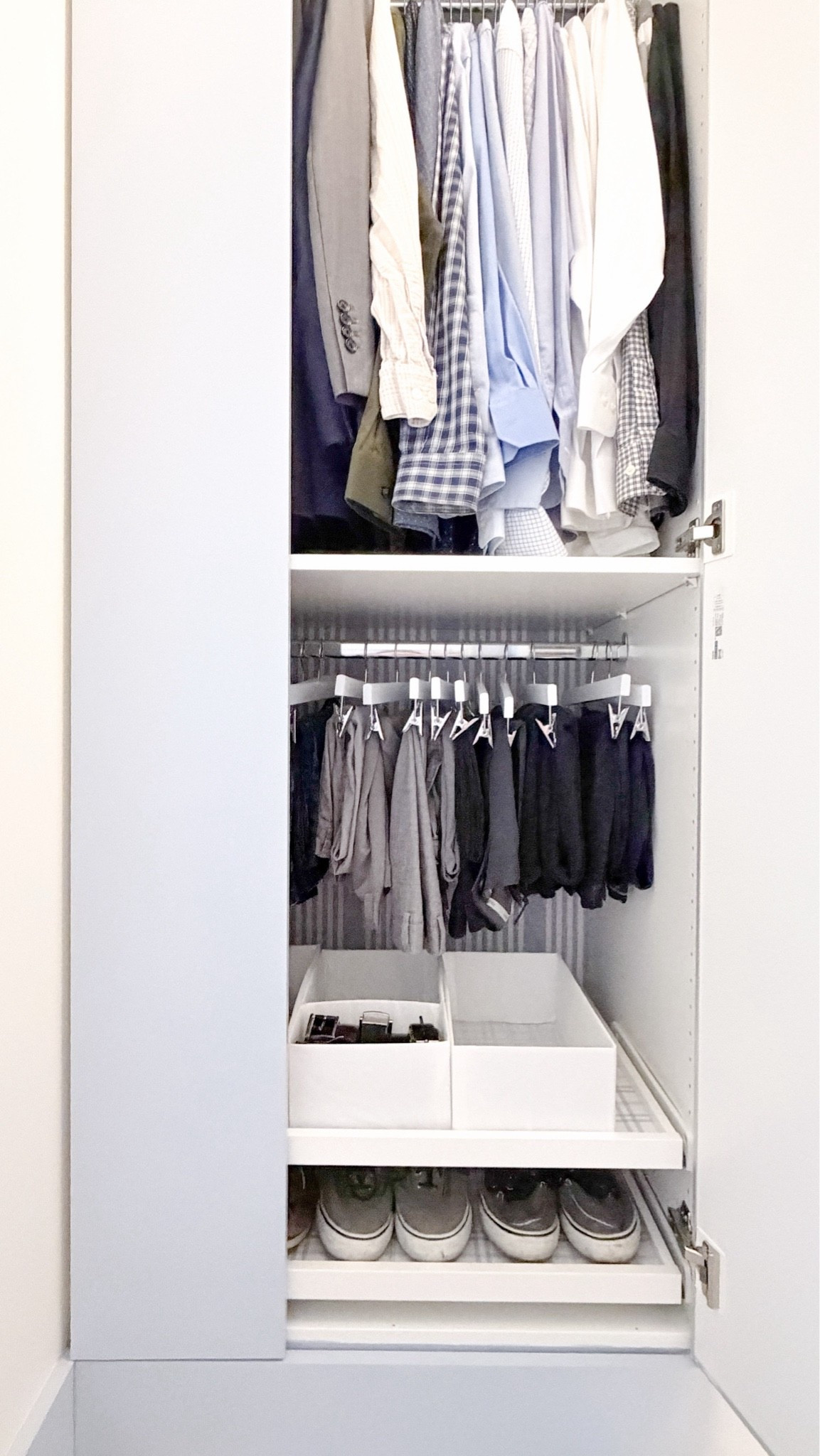 A peek inside one of my husband’s Ikea pax wardrobe for his work clothes. This is the shorter, deep version of the 29” wardrobe. He has two 29” wardrobes that are side by side & we split the doors so there's two 19” mirrors in the center & the 9” flat doors that got painted blue on the outsides. This side features a hanging section on top, a shelf, more hanging for pants, and then two slide out trays with some dividers for extra hangers & belts & another shelf below for additional shoes. Closet organization, mens closet

#LTKHome #LTKMens