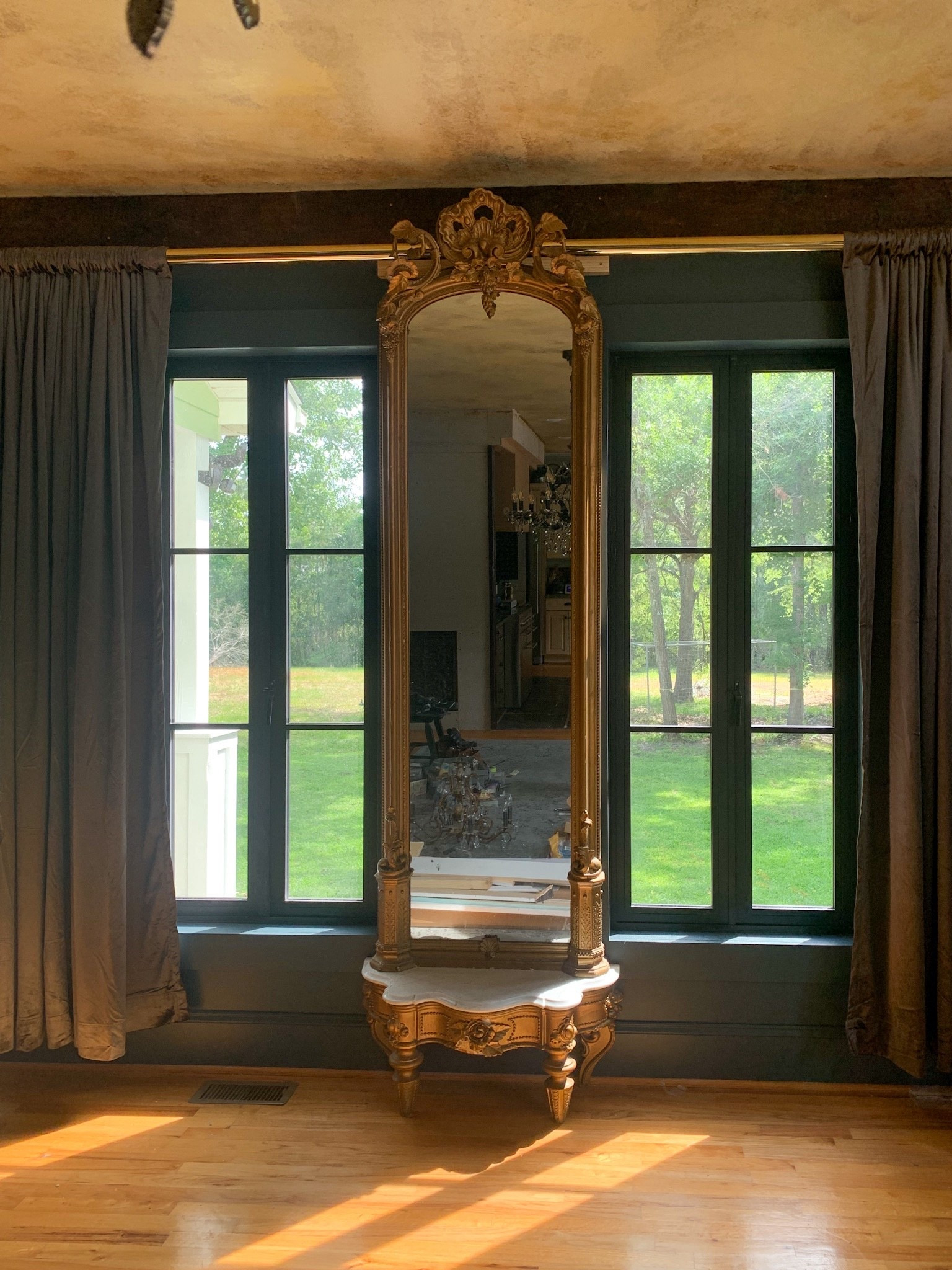 A long elegant mirror paired with a brass curtain rod and dark grey velvet curtains creates a look that feels rich, layered, and effortlessly refined. The mix of soft texture and warm metal adds depth, drama, and timeless sophistication. 

#StatementMirror #VelvetCurtains #BrassDetails #TimelessInteriors #MoodyDecor #HomeDecor #DesignDetails #callsigndesign
