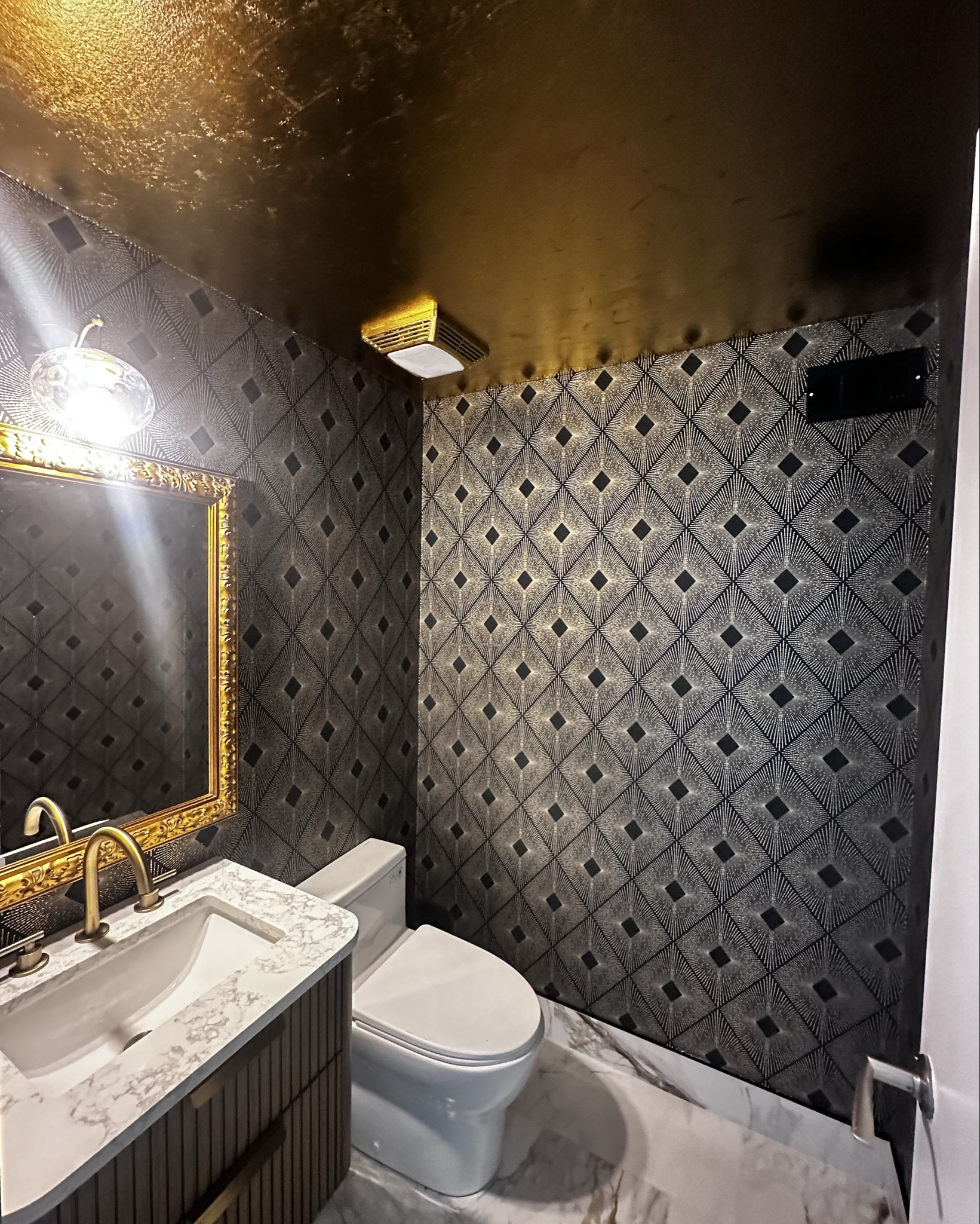 Dark and moody powder room with a little glam! The gold leaf ceiling is everything!

#LTKHome