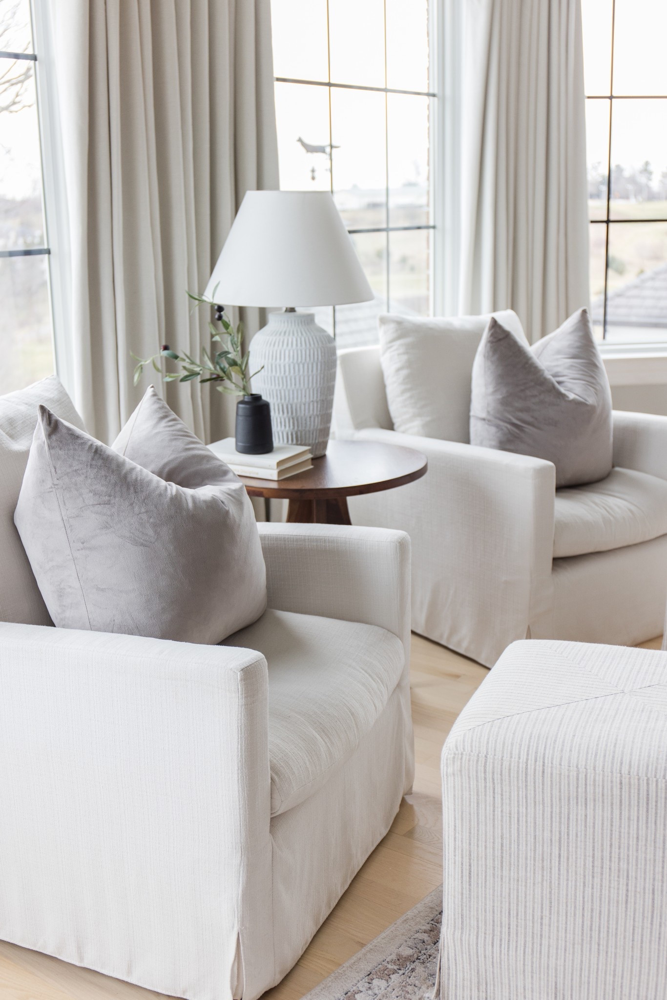 A fresh and bright view of our primary bedroom seating area featuring comfy white chairs and our very favorite black out curtains!

#LTKSeasonal #LTKHome #LTKselfcare