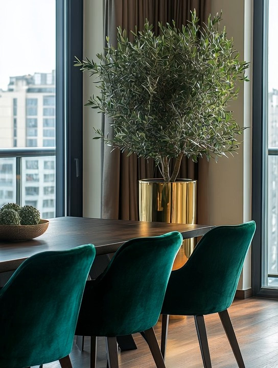 Elegance and simplicity come together beautifully in this timeless dining room design.
A natural dark wood dining table grounds the space, while velvet dining chairs add softness and depth without overpowering the room. The rich textures create balance—warm, inviting, and effortlessly refined. A single gold planter placed in the corner introduces just the right touch of metallic warmth, elevating the look while keeping it understated.

This dining room style works anywhere. Whether you’re designing a high-rise space filled with natural light and expansive views, or a well-lit dining room at home, the combination of wood, velvet, greenery, and subtle gold accents feels universally elegant. Natural light enhances the materials, allowing the space to feel open, calm, and welcoming throughout the day.

What makes this look truly timeless is its balance of simplicity and boldness. Clean lines, rich textures, and a few intentional statement pieces come together to create a dining room that feels modern yet enduring—beautiful without being overdesigned.

#TimelessDining #ElegantHomeStyle #ModernClassicDecor 

 #LTKHome
