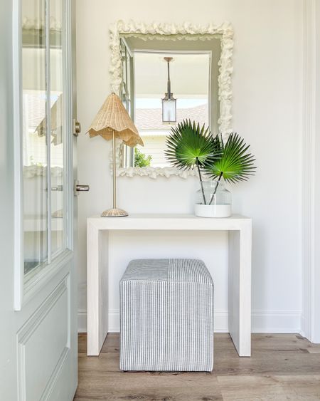 Loving how our Florida cottage entryway is coming together! We ordered this small console table to fit perfectly in the space and paired it with this coral mirror, scalloped rattan lamp, paint dipped vase filled with faux fan palms, and our favorite striped ottoman cube! . coastal decor, beachy style, foyer design

#ltkhome #ltksalealert #ltkunder50 #ltkunder100 #ltkstyletip #ltkseasonal 

#LTKsalealert #LTKhome #LTKunder100 #LTKsalealert #LTKSeasonal #LTKhome