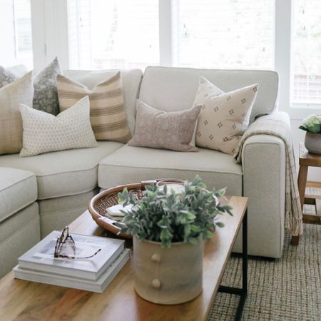 In our living room I chose a Pottery Barn Pearce sectional with neutral pillow covers and a wood coffee table  

#LTKhome #LTKFind #LTKstyletip