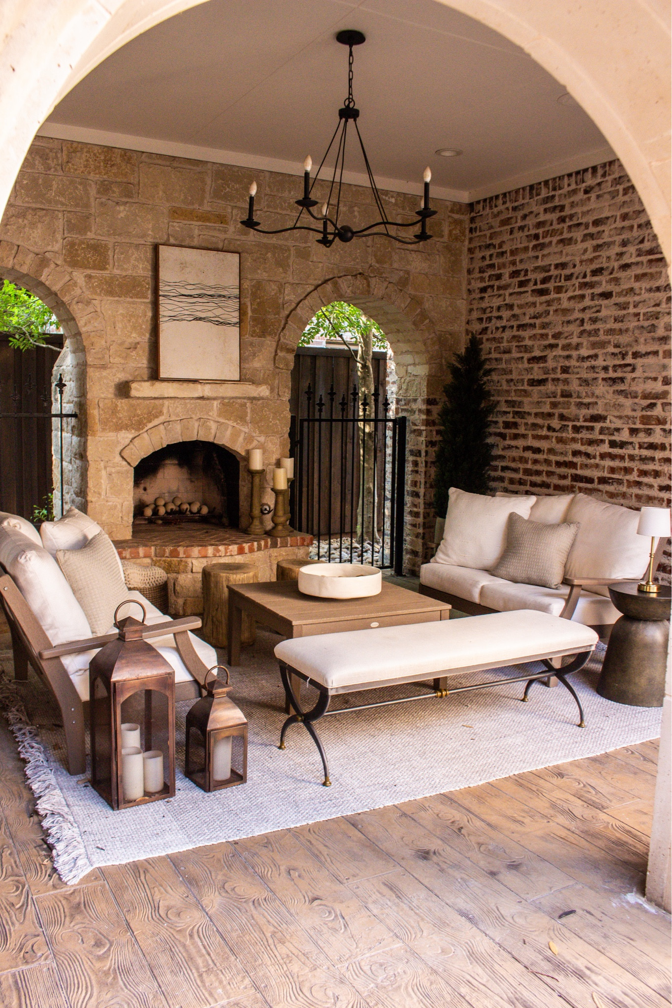 The easiest way to elevate your outdoor space is layering textures like this. Neutral cushions, woven rug, lantern decor, and a statement fireplace make it feel so inviting.

#LTKHome #LTKSeasonal