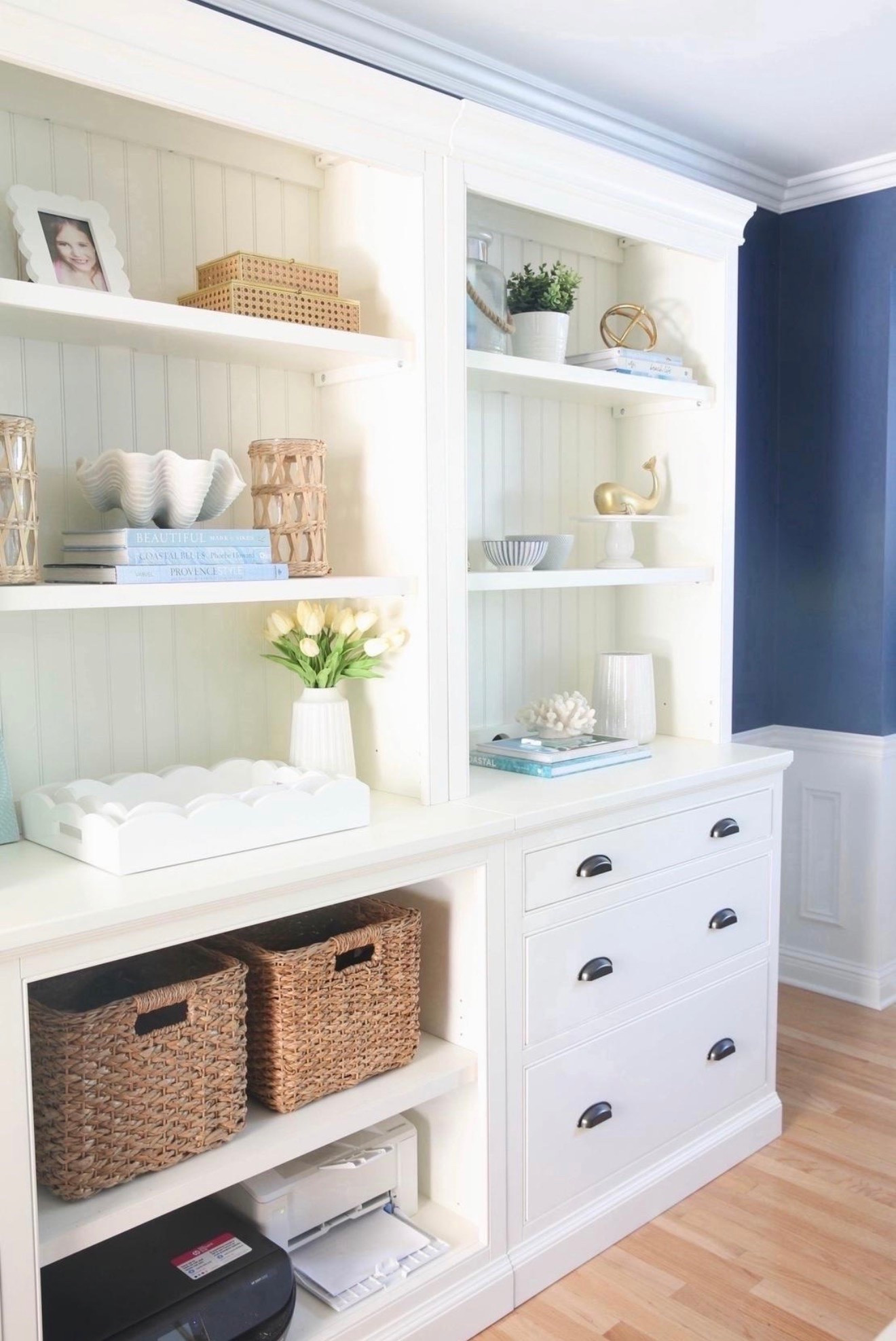 This blue dining room doubles as my home office with a white table, a white entertainment center with bookshelves and filing cabinets, and a jute rug for a modern coastal look. I love how the blue walls paired with crisp white furniture and natural textures make this space feel bright, functional, and designer-inspired.

#LTKHome #LTKSaleAlert