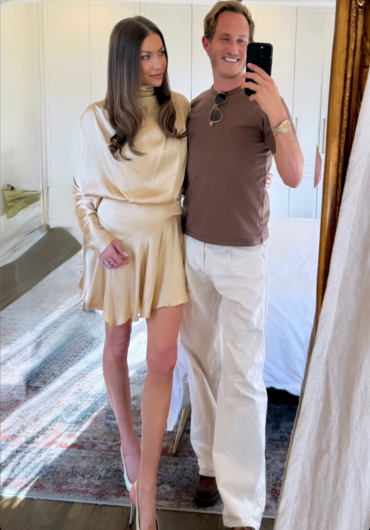 Stassi Schroeder's mini dress is crafted from satin with a softly draped silhouette that follows the body naturally, giving the shorter shape a relaxed sense of movement.