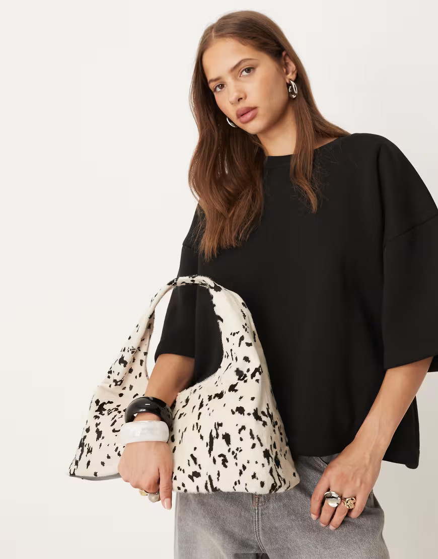 ASOS DESIGN pony hair mid size slouch shoulder bag in cow print-Multi | ASOS (Global)