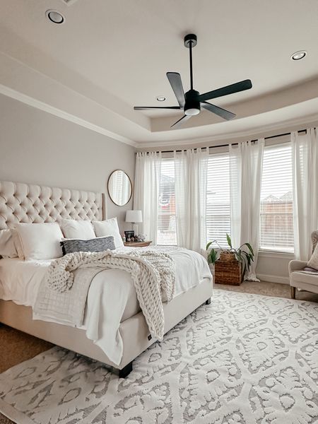Neutral bedroom decor. Indoor outdoor rug. Upholstered king size bed. White bedding. Chunky knit blanket  

#LTKfindsunder100 #LTKstyletip #LTKhome