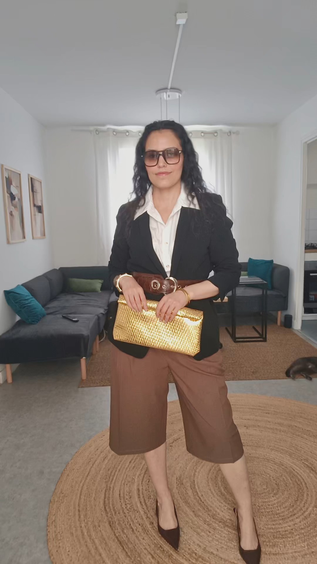 How to style a chic restaurant look for Saturday night ✨Wearing a timeless outfit built on strong basics and clean structure.I paired a black blazer with a white shirt to create contrast and bring light to the look.Adding a belt to cinch the waist instantly elevates the silhouette and gives that polished, elegant feel.The long bermuda (tailored pantacourt) is one of the key trends right now —comfortable, modern, and perfect with heels to elongate the legs.For accessories, I went with gold jewelry and a gold clutch for a refined, cohesive finish ✨Finished with Prada sunglasses for a confident, sophisticated touch.A simple outfit, but intentionally styled to enhance the silhouette and create balance.Shop the look below ⬇️#ltkstyle #ltkfashion #ltkootd #outfitoftheday#zara #mango #hm #asos #minimalstyle#chicstyle #effortlessstyle #capsulewardrobe#fashioninspo #streetstyle #elevatedbasics

