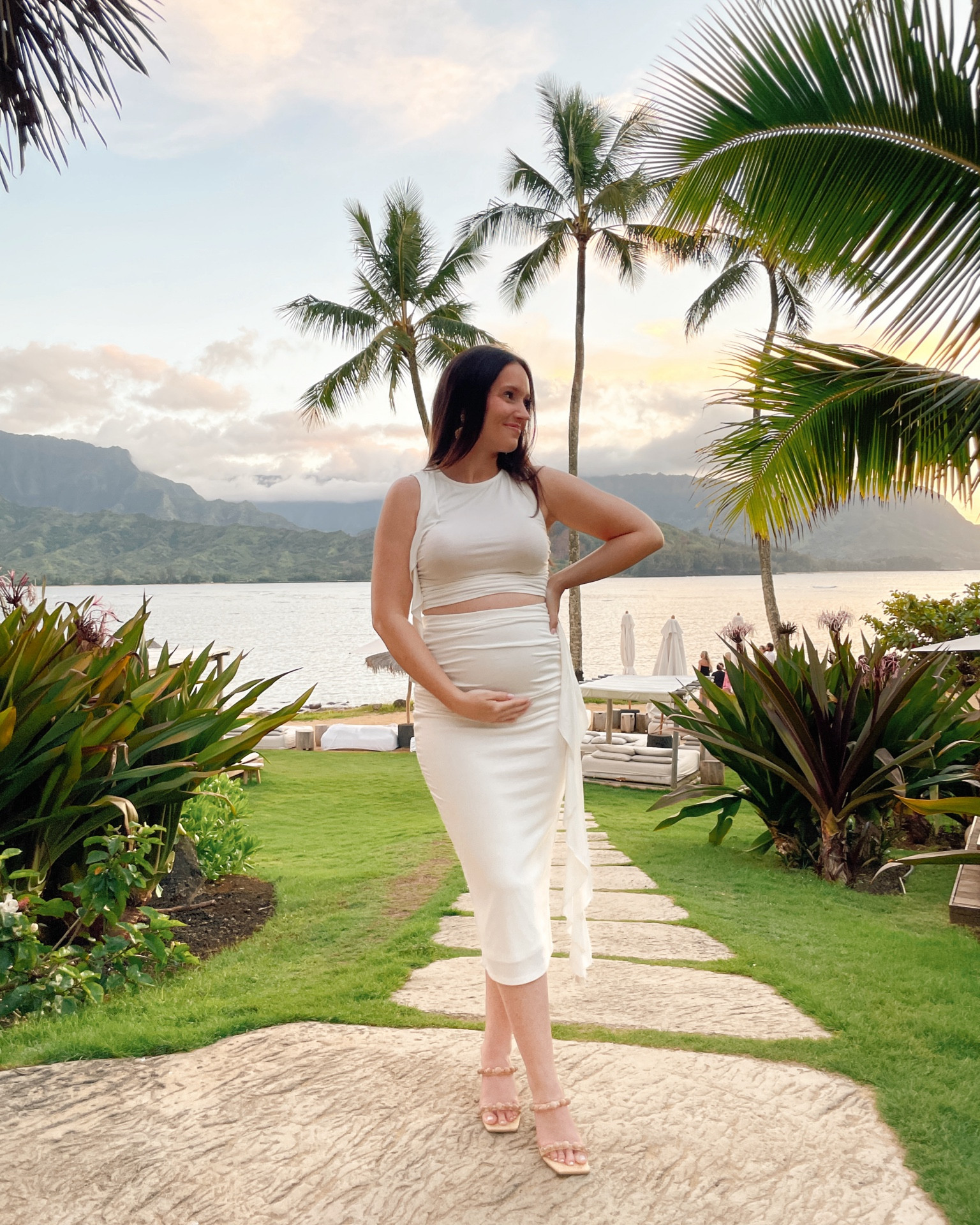 Beach Vacation outfit! Wore this lulus two piece set for a date night in Kauai 🌴 this white dress is very bump friendly. The skirt is double lined and the top isn’t lined so you have to wear a sticky bra. Wearing my true size XS and I’m 18 weeks pregnant, 5’1 petite. 

#LTKTravel #LTKBump #LTKFindsUnder100
