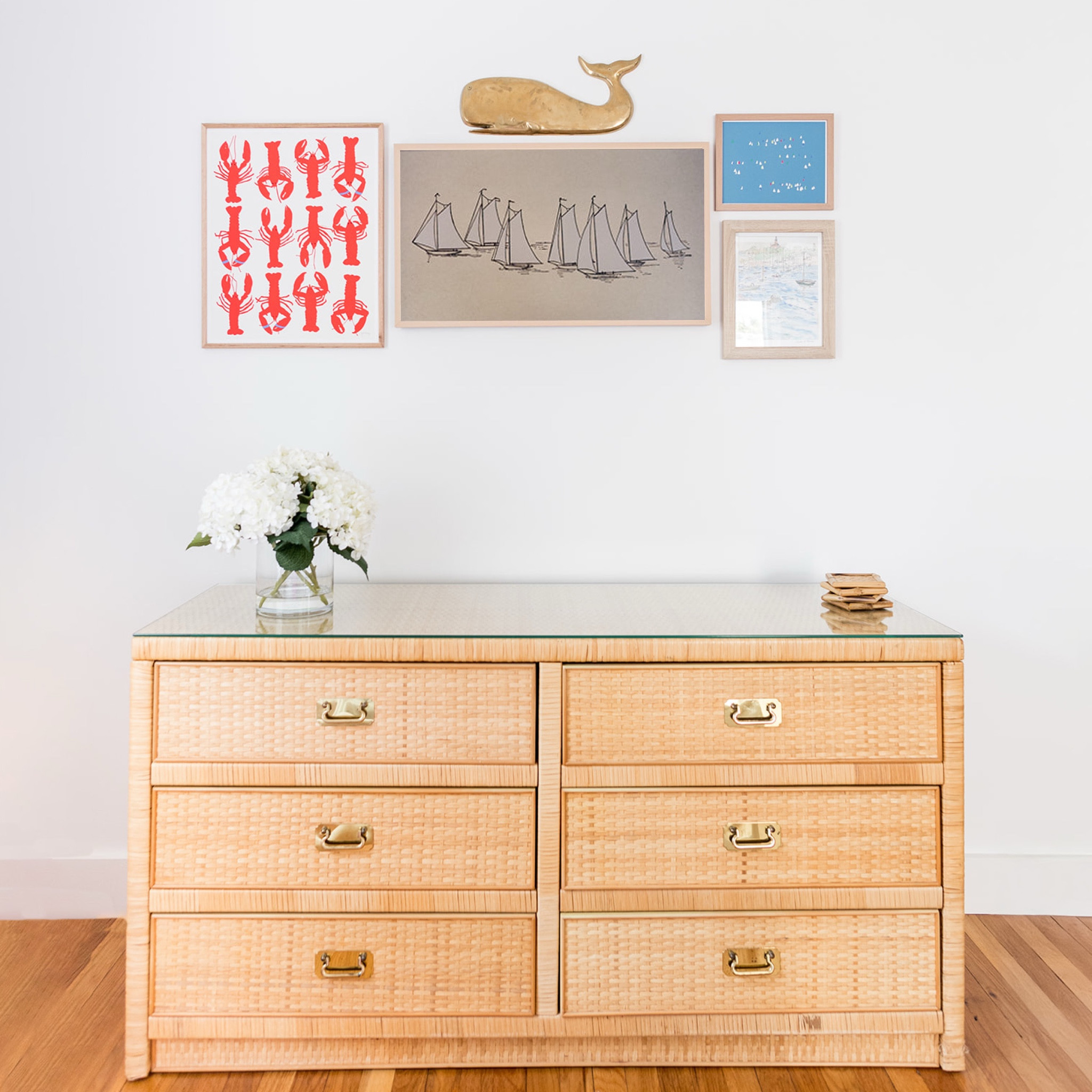 when selecting furniture and artwork for the #mixedusemini, we aimed to incorporate as many vintage and local pieces as we could find. because this property is a #dwelloctoberstay vacation rental, we wanted it to have a comfortable lived-in feel and lots of character. we found this vintage rattan dresser @vintageon2 and repurposed it to hold board games, playing cards, and extra blankets. a Frame TV is camouflaged by a collection of local artwork, including prints from @joreyhurley and a brass whale from @seacraftvintage. #dwelloctober

#LTKFindsUnder50 #LTKHome